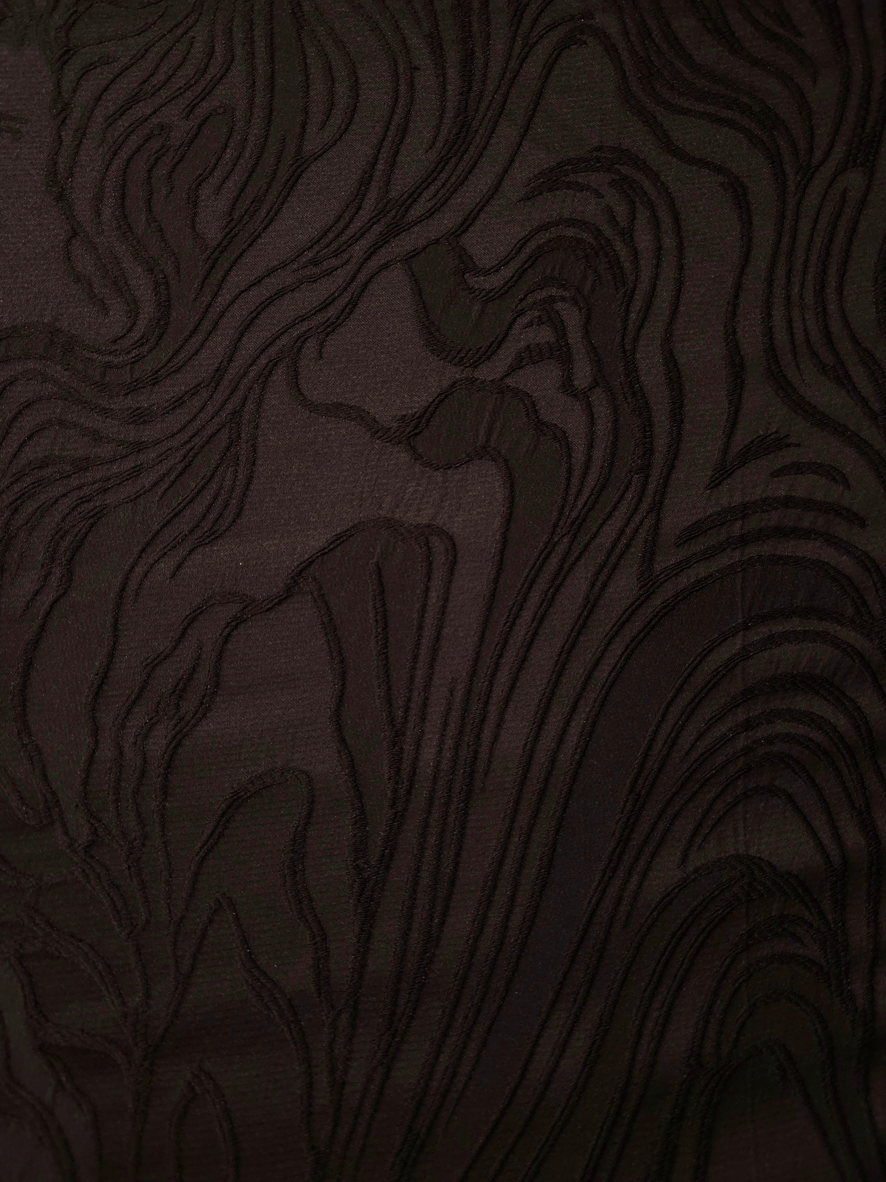 Full view of brown branch polyester crepe jacquard fabric with raised woven texture.