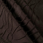 Pattern detail of brown laurel polyester crepe jacquard fabric with raised woven texture.