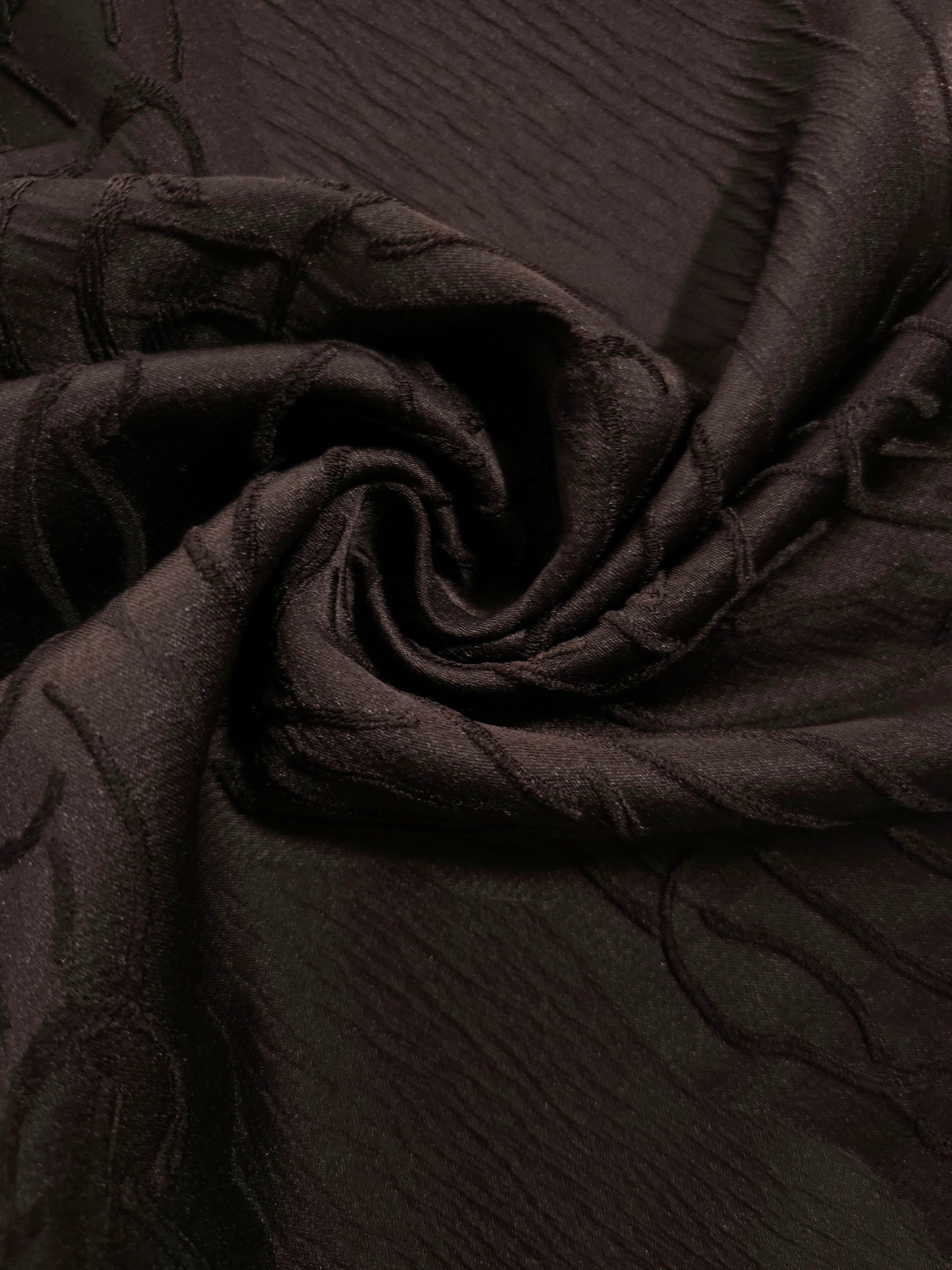 Wide view of brown laurel polyester crepe jacquard fabric for tailored modestwear layers.