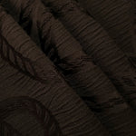 Pattern detail of brown wheat leaf polyester crepe jacquard fabric with raised texture.