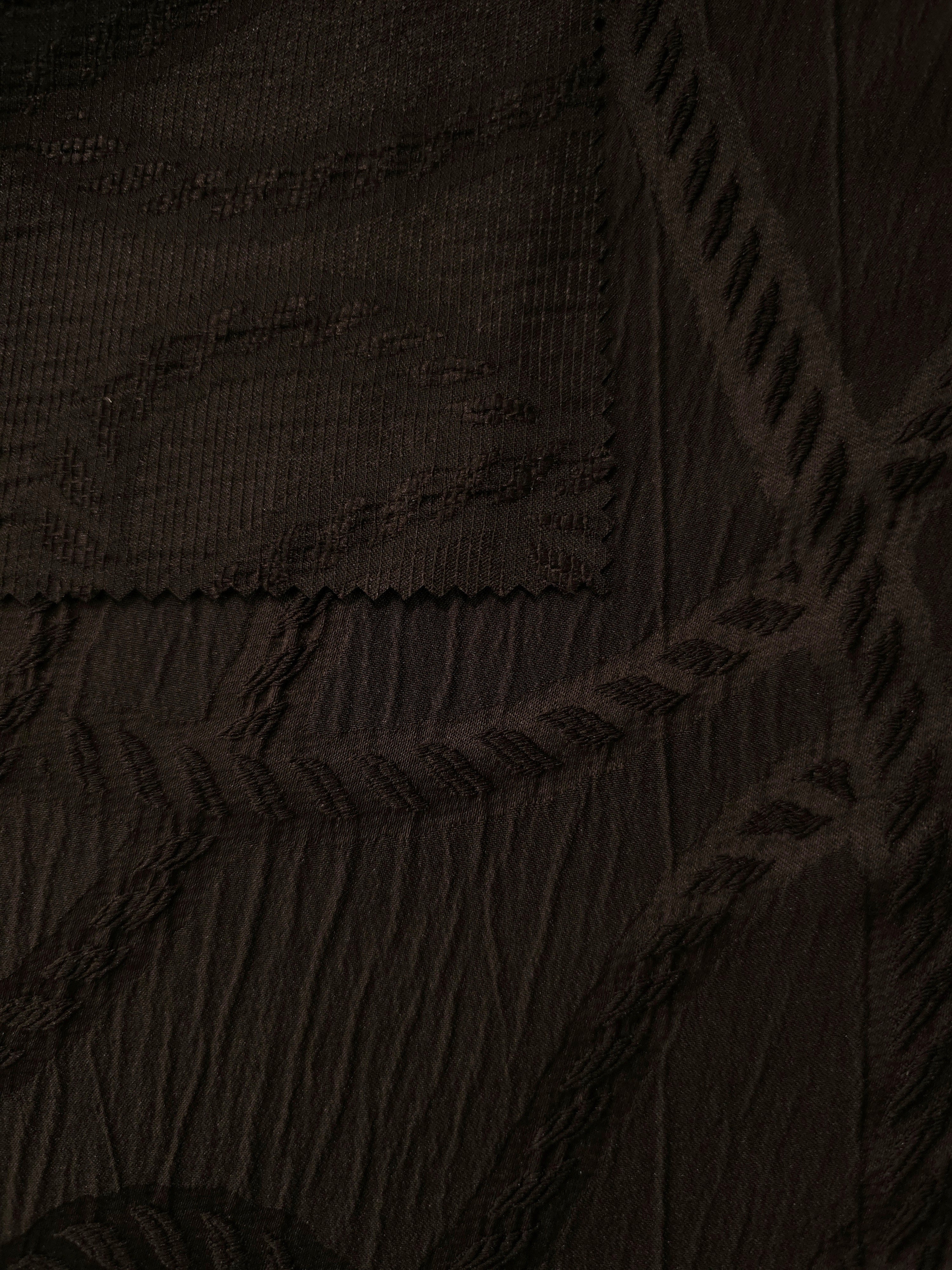 Closeup texture of brown wheat leaf polyester crepe jacquard fabric for tailored garments.