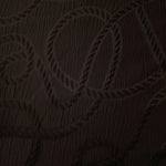 Full view of brown wheat leaf polyester crepe jacquard fabric with tonal raised motif.