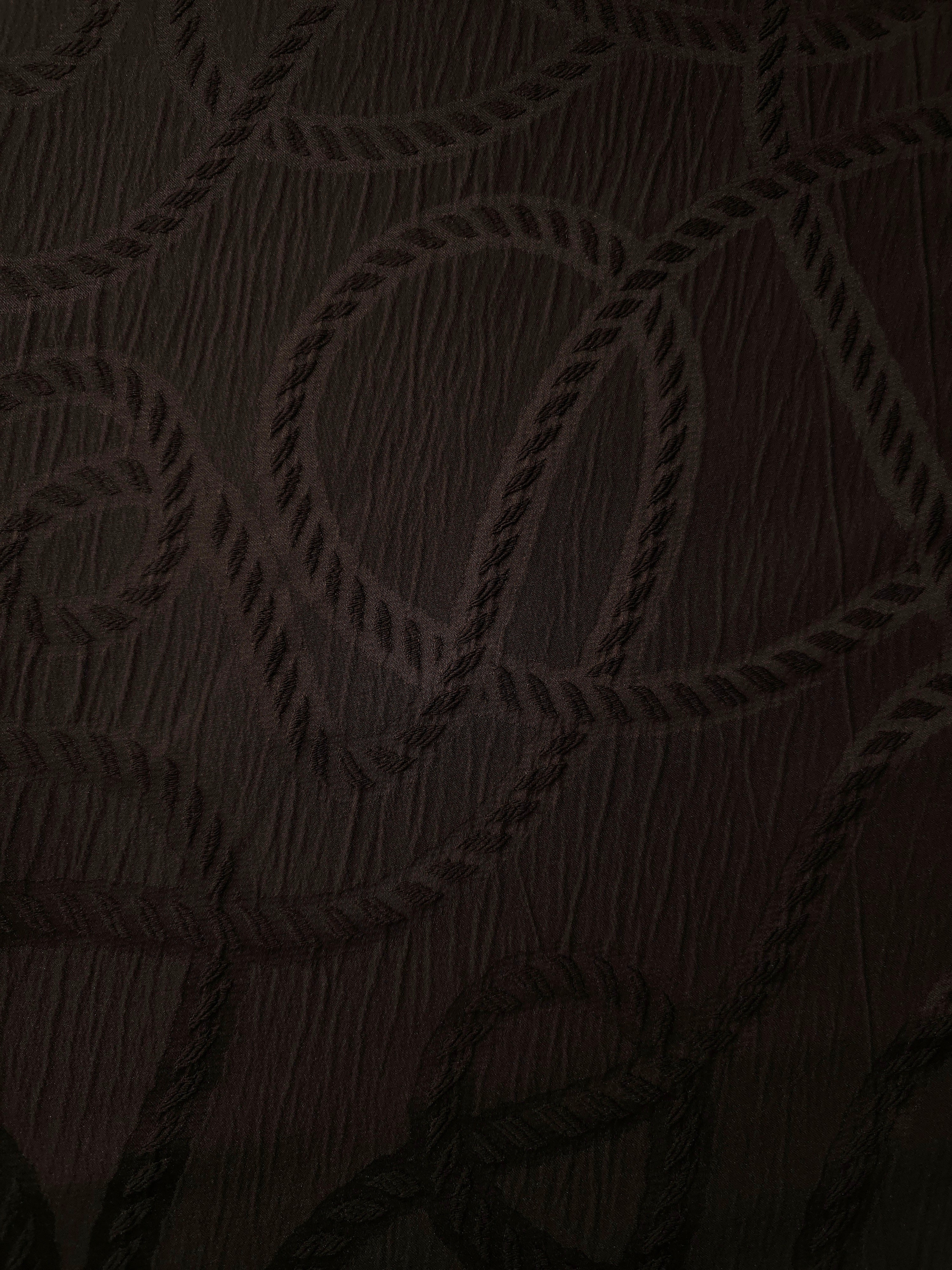 Full view of brown wheat leaf polyester crepe jacquard fabric with tonal raised motif.