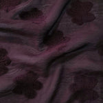 Pattern detail of dark burgundy flower embossed viscose jacquard fabric.