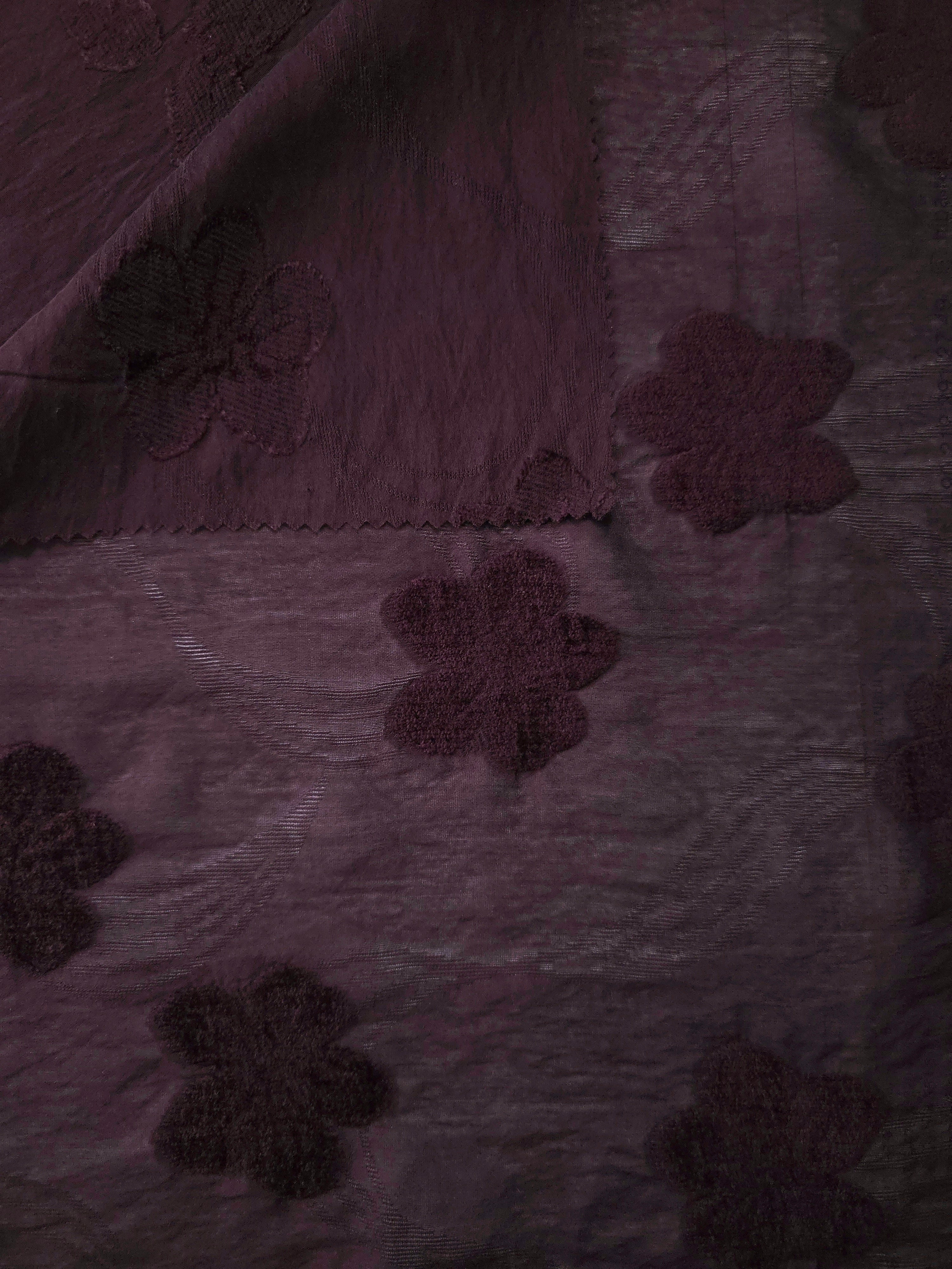 Front and back view of dark burgundy flower embossed viscose jacquard fabric.