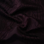 Burgundy laurel polyester crepe jacquard fabric in a textured drape for dresses.