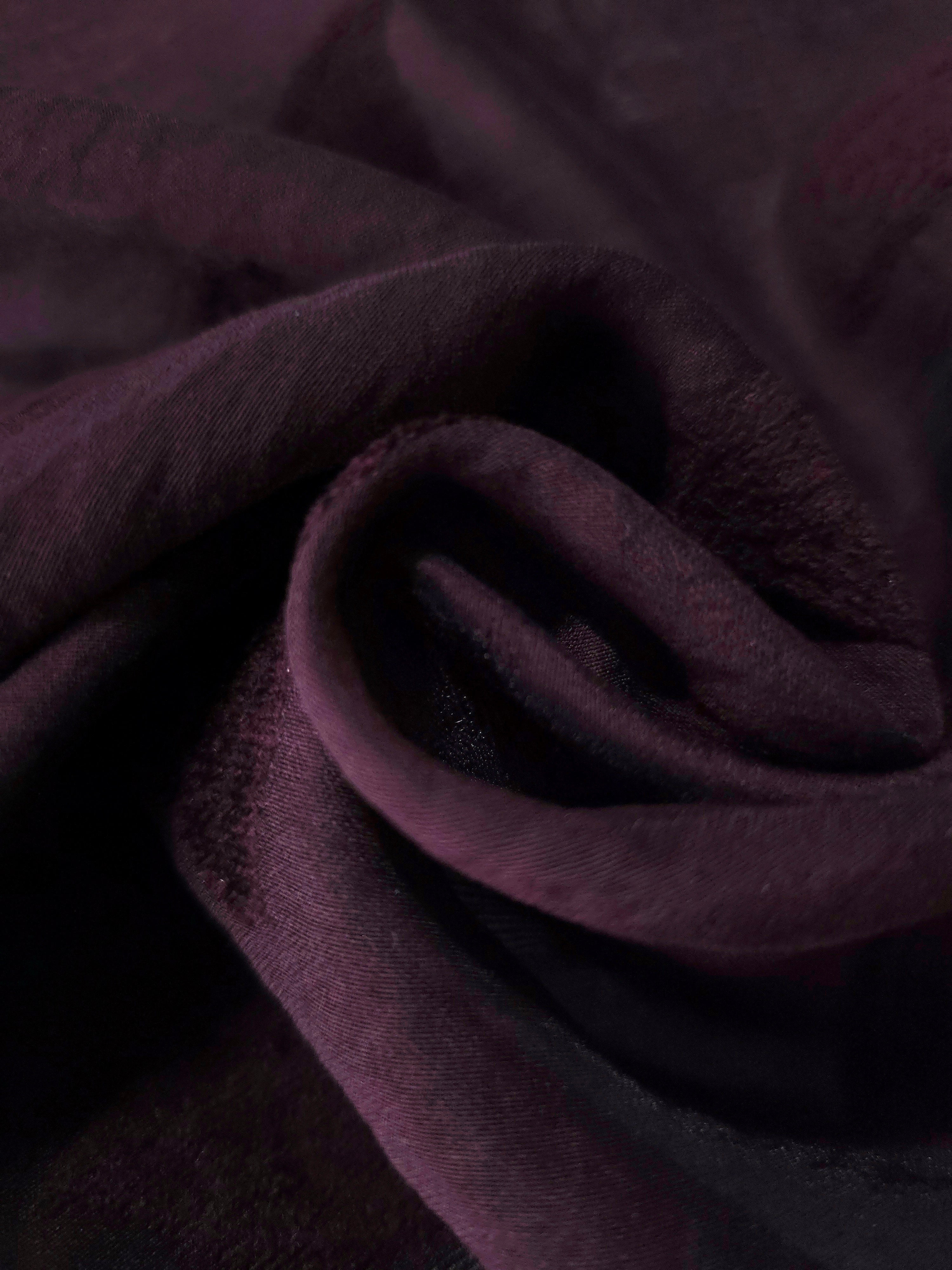 Dark burgundy leaf embossed viscose jacquard fabric in a close draped view for overlays.