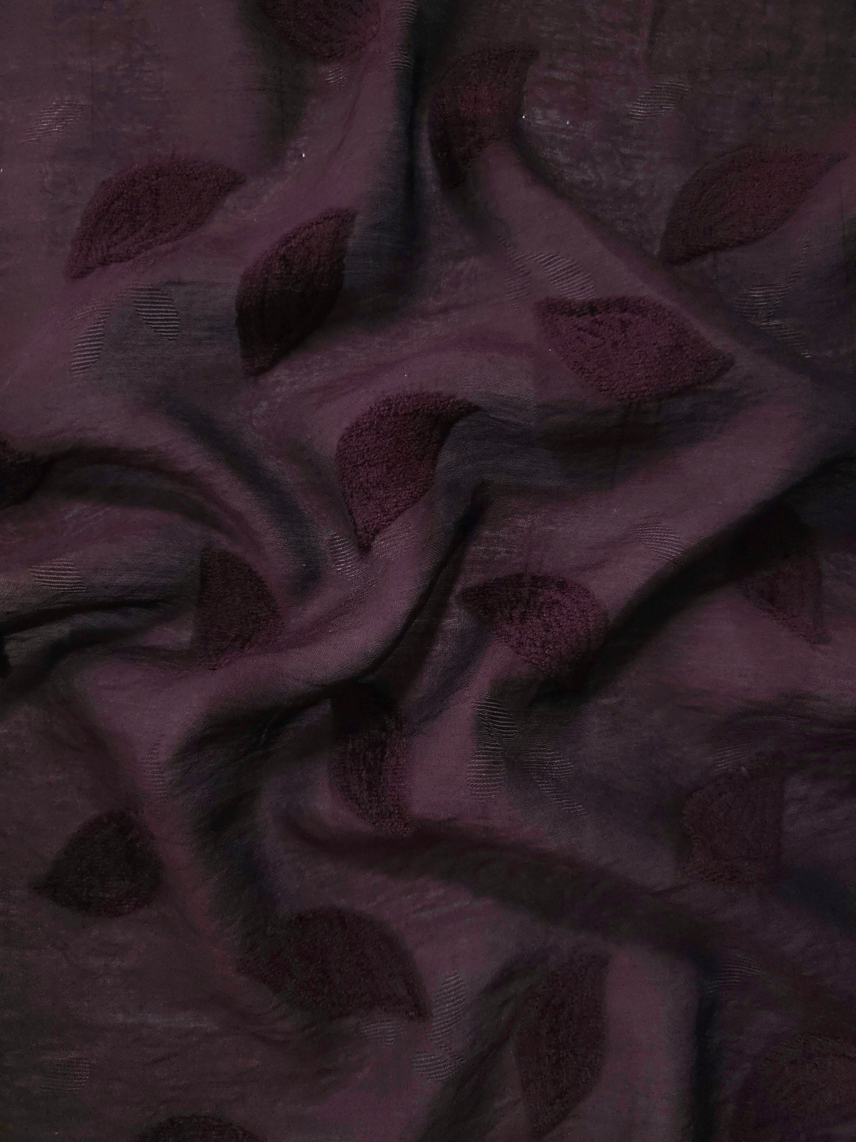 Pattern detail of dark burgundy leaf embossed viscose jacquard fabric with raised motif.