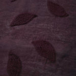 Front and back view of dark burgundy leaf embossed viscose jacquard fabric.