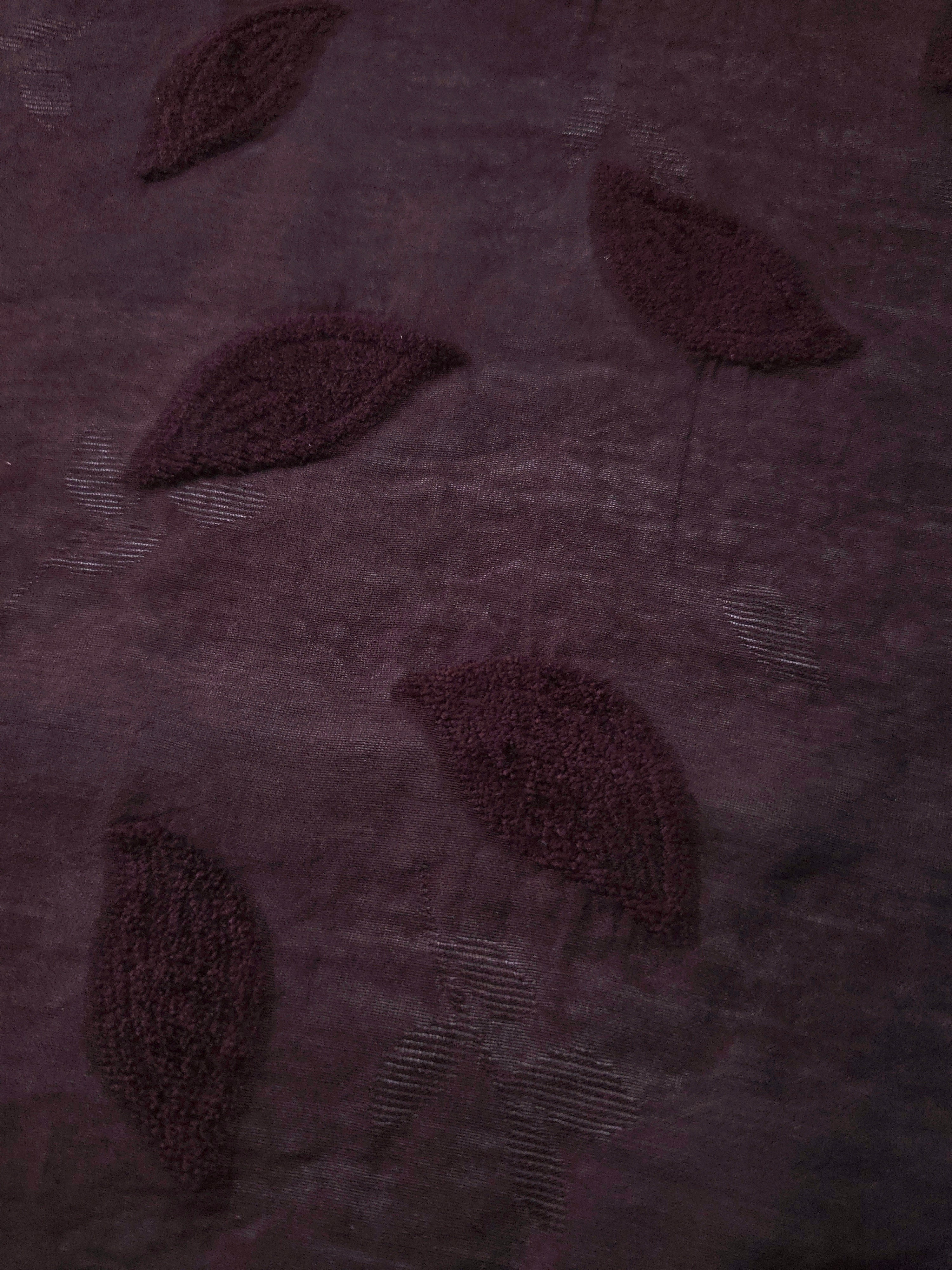 Front and back view of dark burgundy leaf embossed viscose jacquard fabric.