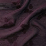 Pattern detail of dark burgundy small leaf embossed viscose jacquard fabric.