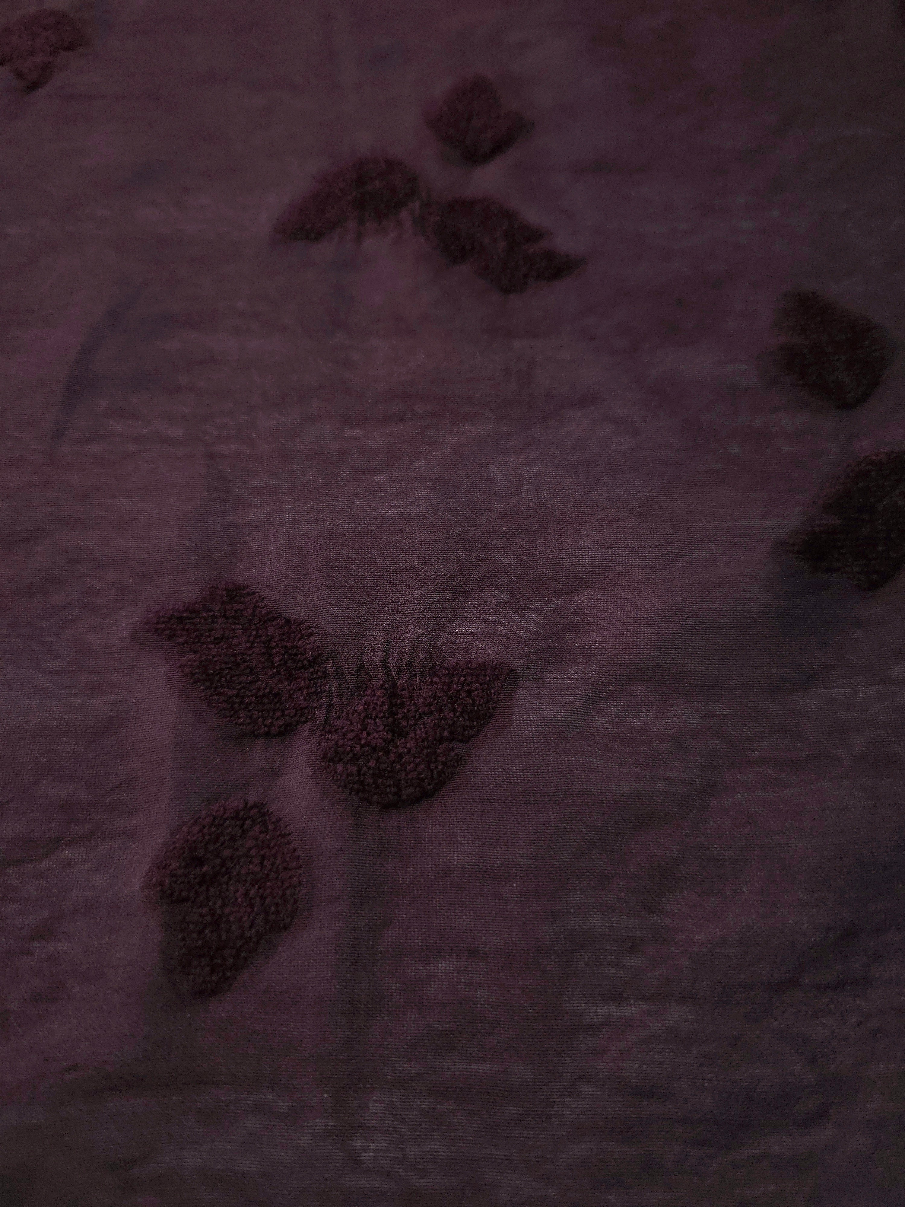 Front and back view of dark burgundy small leaf embossed viscose jacquard fabric.