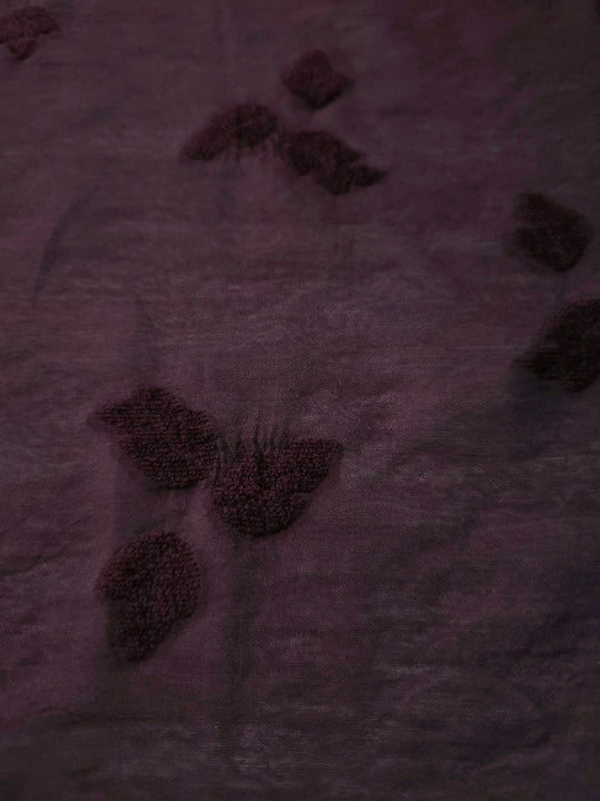 Front and back view of dark burgundy small leaf embossed viscose jacquard fabric.
