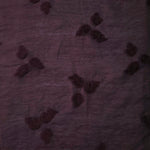 Drape view of dark burgundy small leaf embossed viscose jacquard fabric for layered dresses.