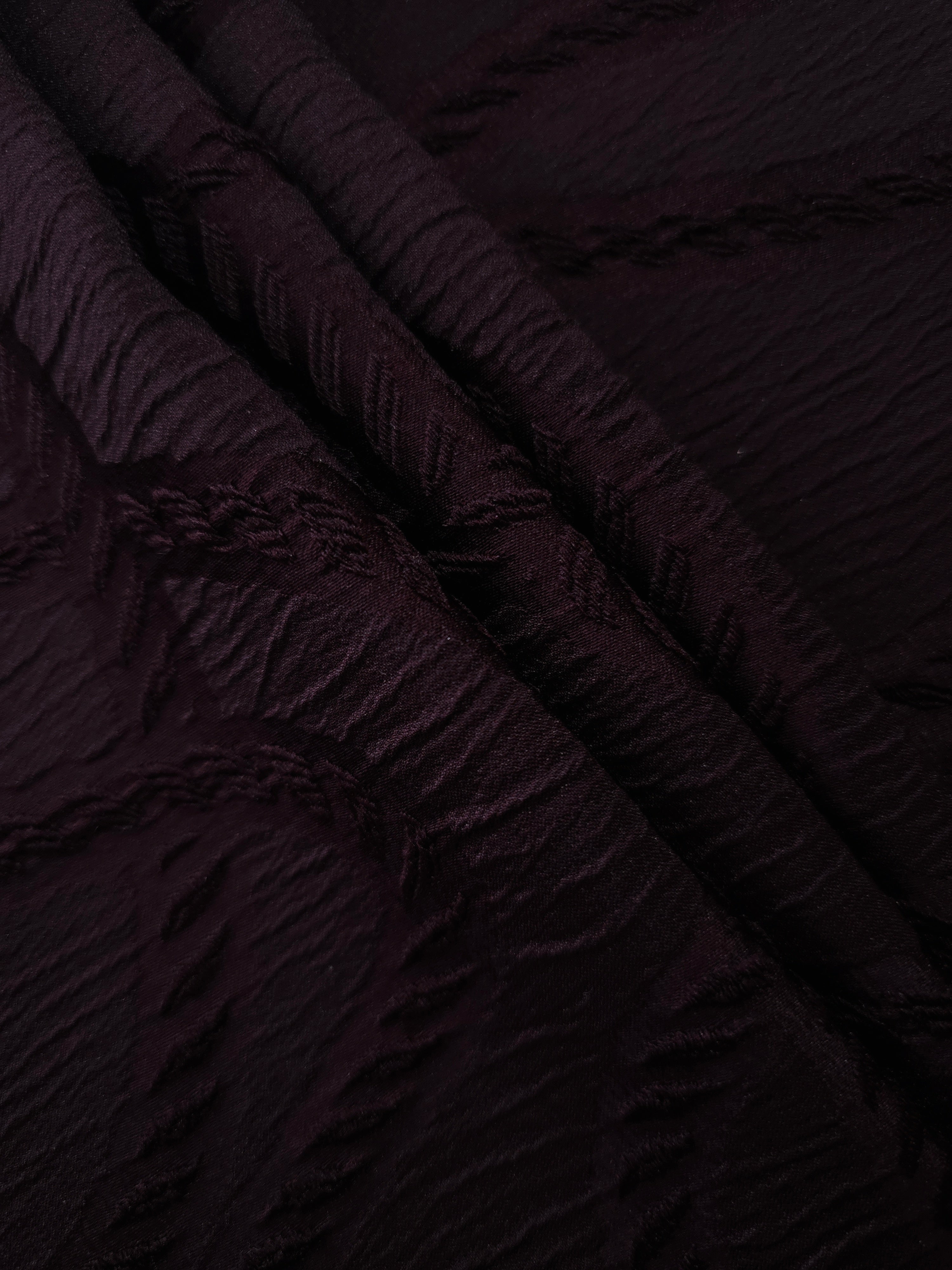 Burgundy wheat leaf polyester crepe jacquard fabric in a textured drape for dresses.