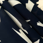 Folded black rayon chiffon Empirme with big flower print for dresses and layers.