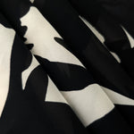 Folded brown rayon chiffon Empirme with big flower print for dresses and layers.