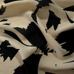 Wave fold of navy blue rayon Empirme fabric with big flower print for occasionwear.