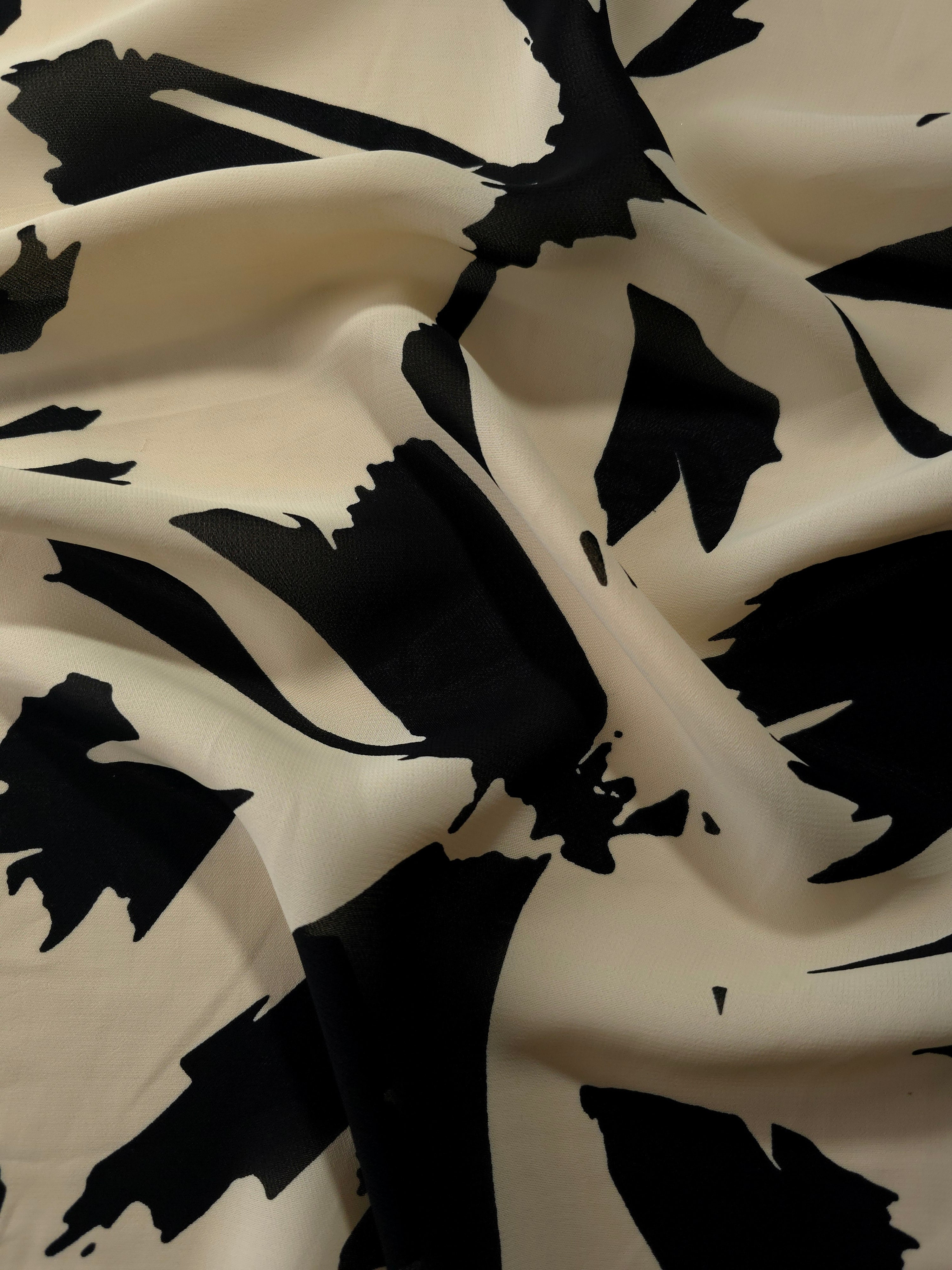 Wave fold of navy blue rayon Empirme fabric with big flower print for occasionwear.