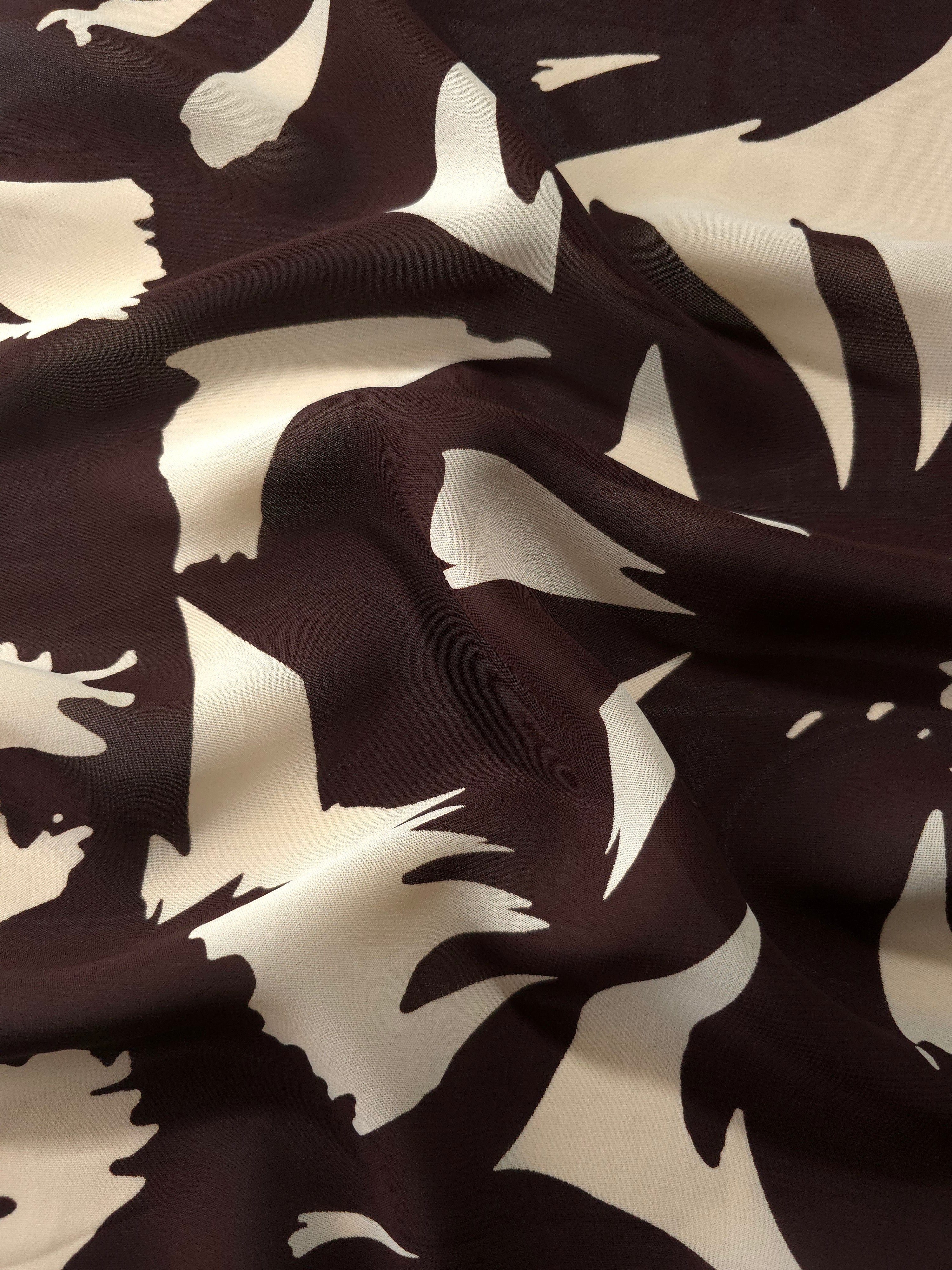 Wave fold of white rayon Empirme fabric with big flower print for summer layers.