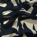 Wave fold of black rayon Empirme fabric with big flower print for occasion layers.