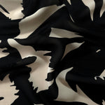 Wave fold of brown rayon Empirme fabric with big flower print for flowing layers.