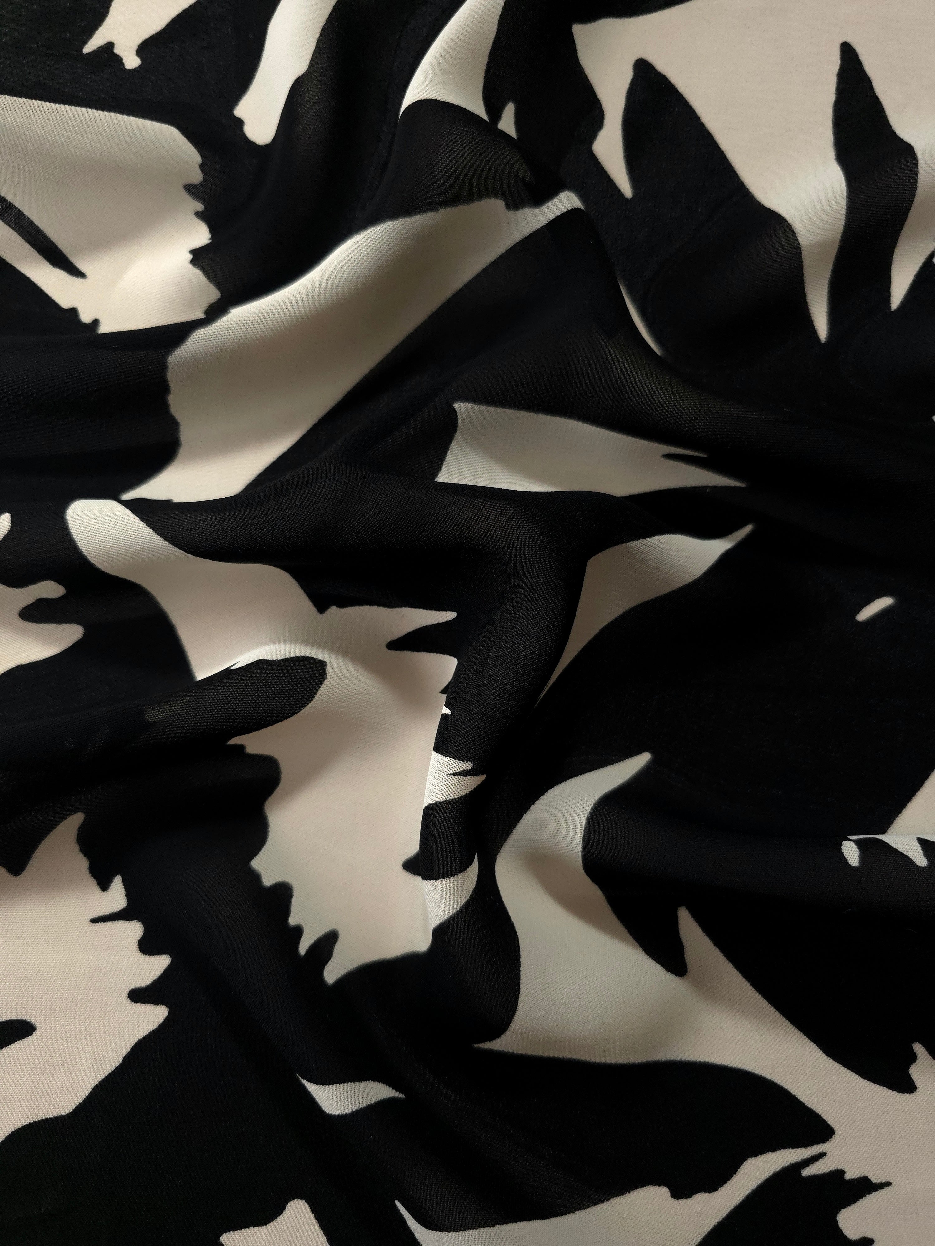 Wave fold of brown rayon Empirme fabric with big flower print for flowing layers.