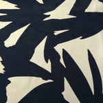 Wide view of black floral rayon chiffon fabric for dressmaking and blouses.