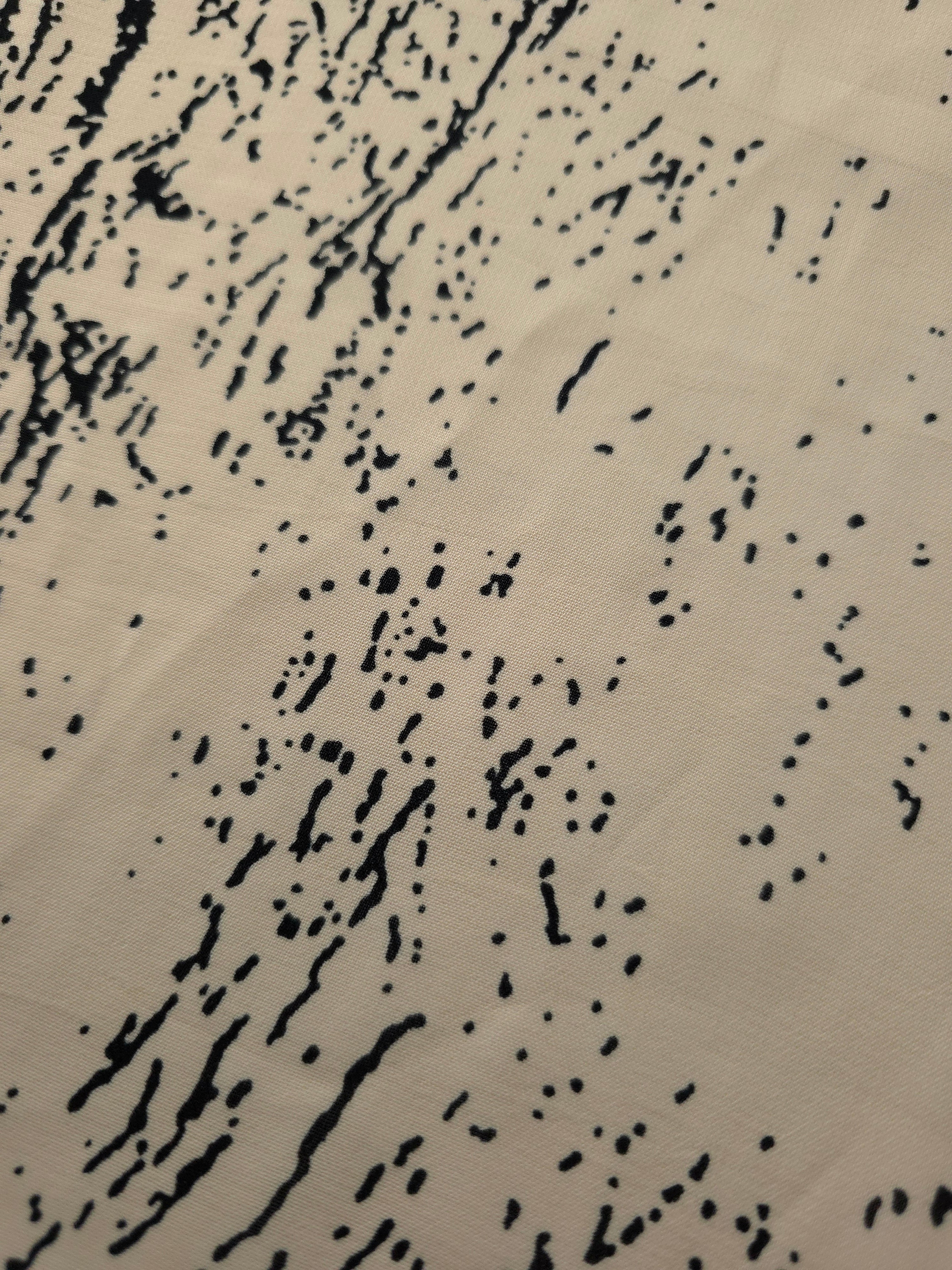 Close-up of black printed rayon chiffon showing graphic Empirme pattern and light weave.