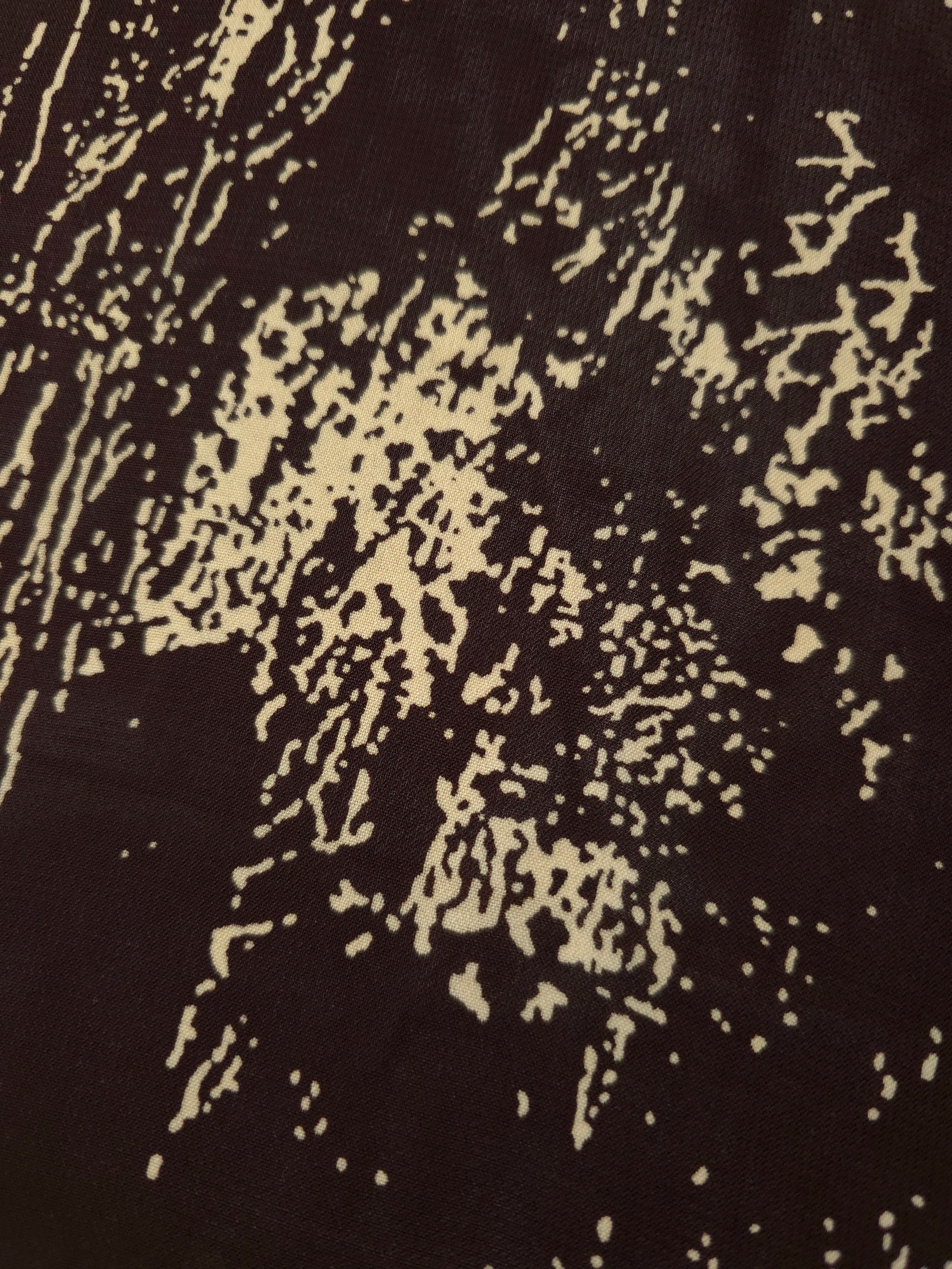 Close-up of brown printed rayon chiffon showing graphic pattern and light weave.