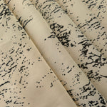 Folded black rayon chiffon Empirme with graphic print for dresses and blouse layers.