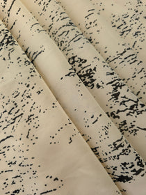 Folded black rayon chiffon Empirme with graphic print for dresses and blouse layers.