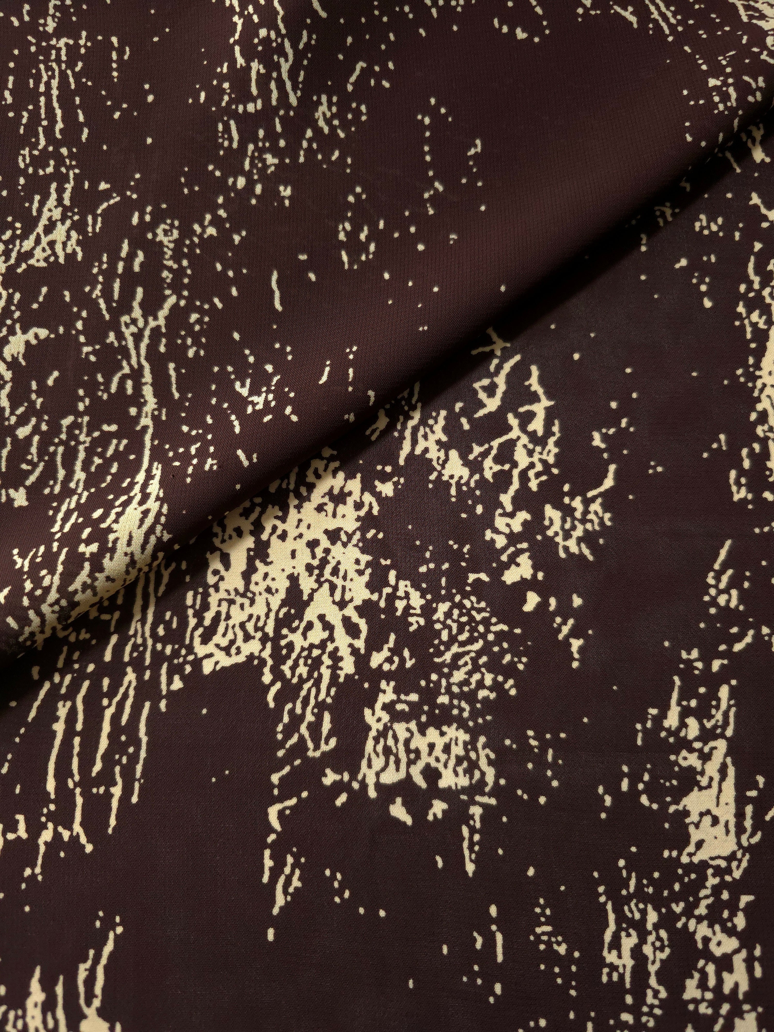Front and back view of brown printed rayon chiffon for opacity and lining checks.