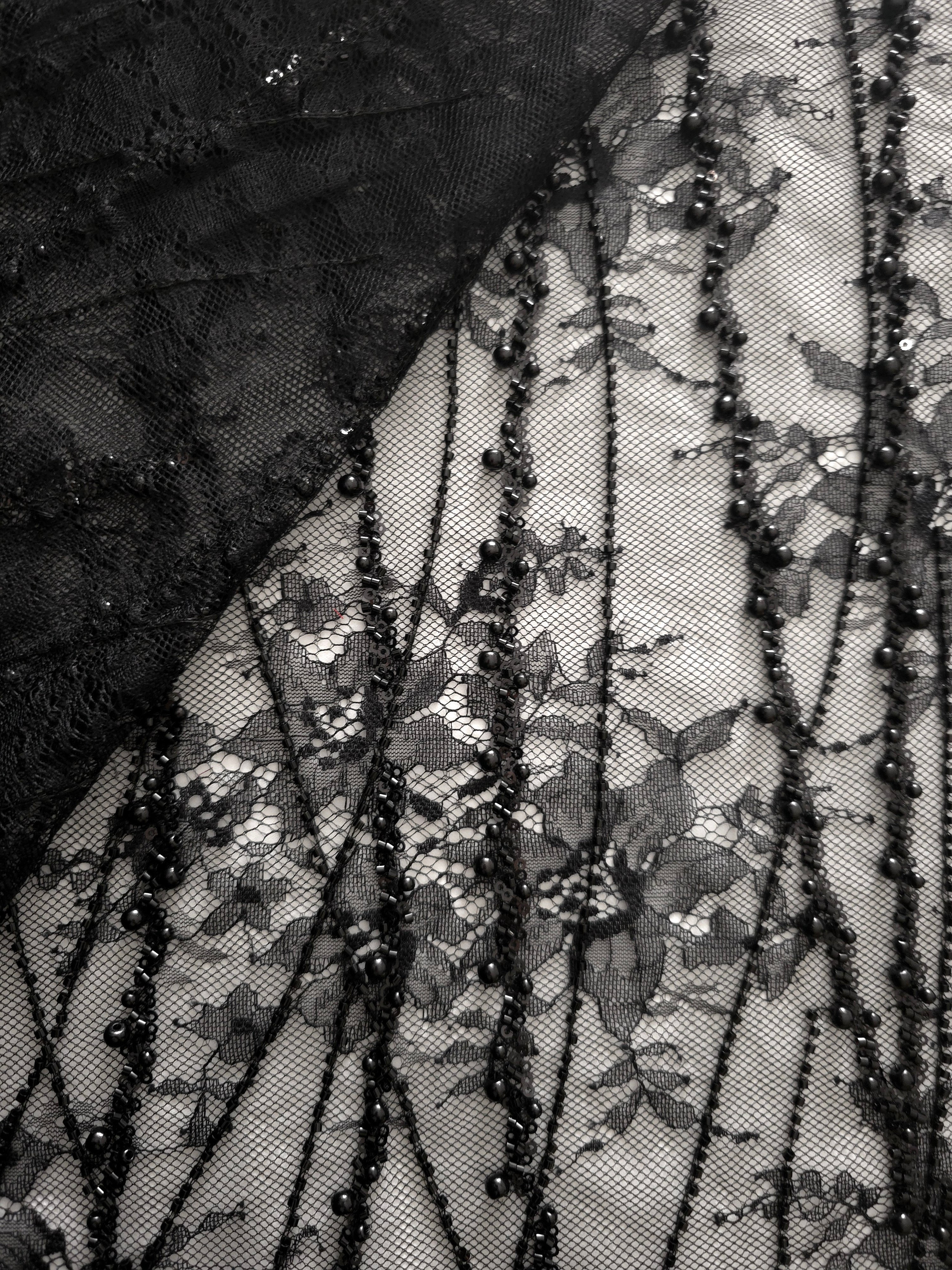 Close-up of Jet Black Botanical Pearl beaded lace showing jet sequin threadwork macro, with branching botanical vines with pearl-like beading.