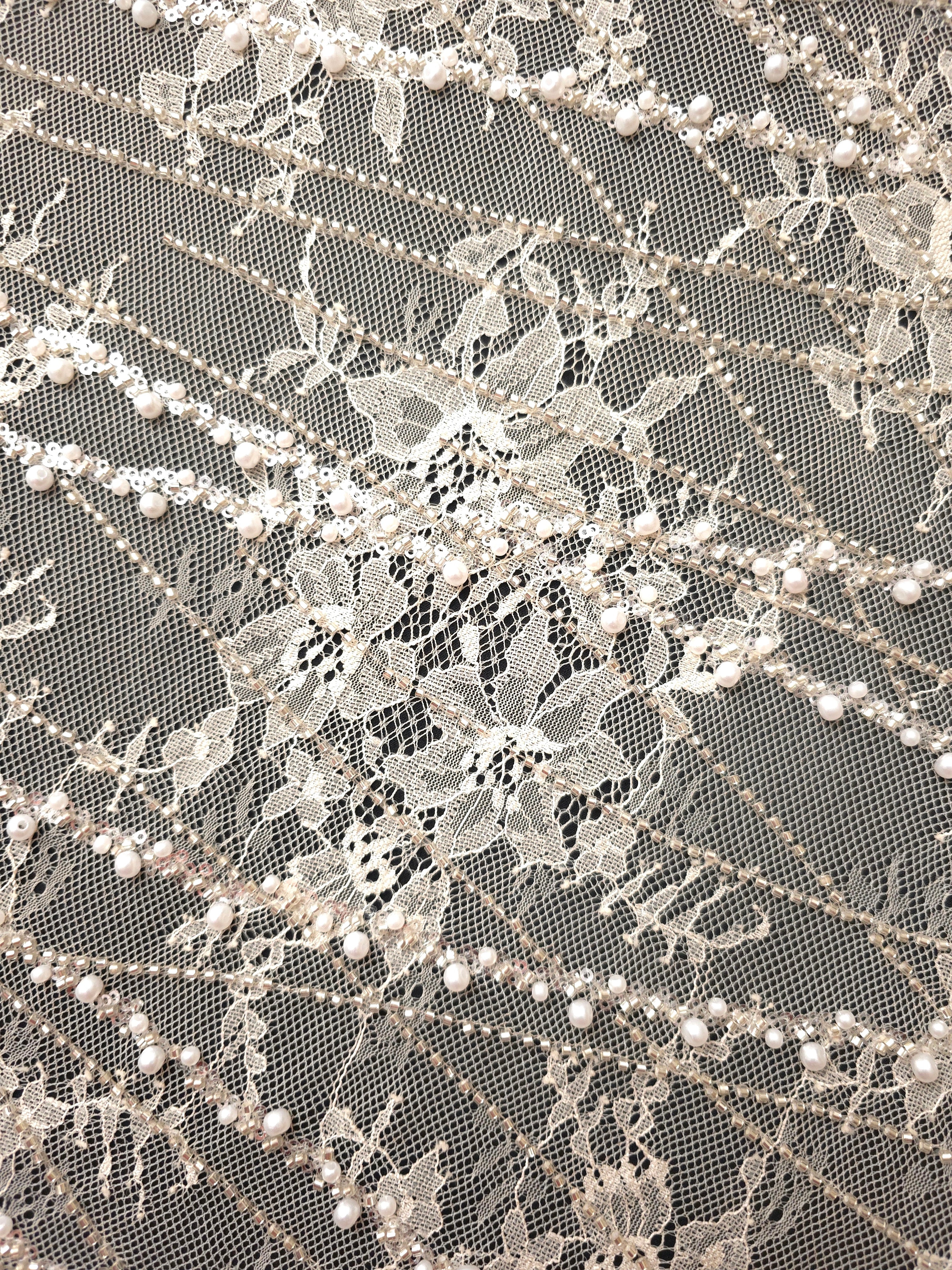 Pearl White Botanical Pearl embellished lace displaying sheer botanical lace visibility, with branching botanical vines with pearl-like beading.