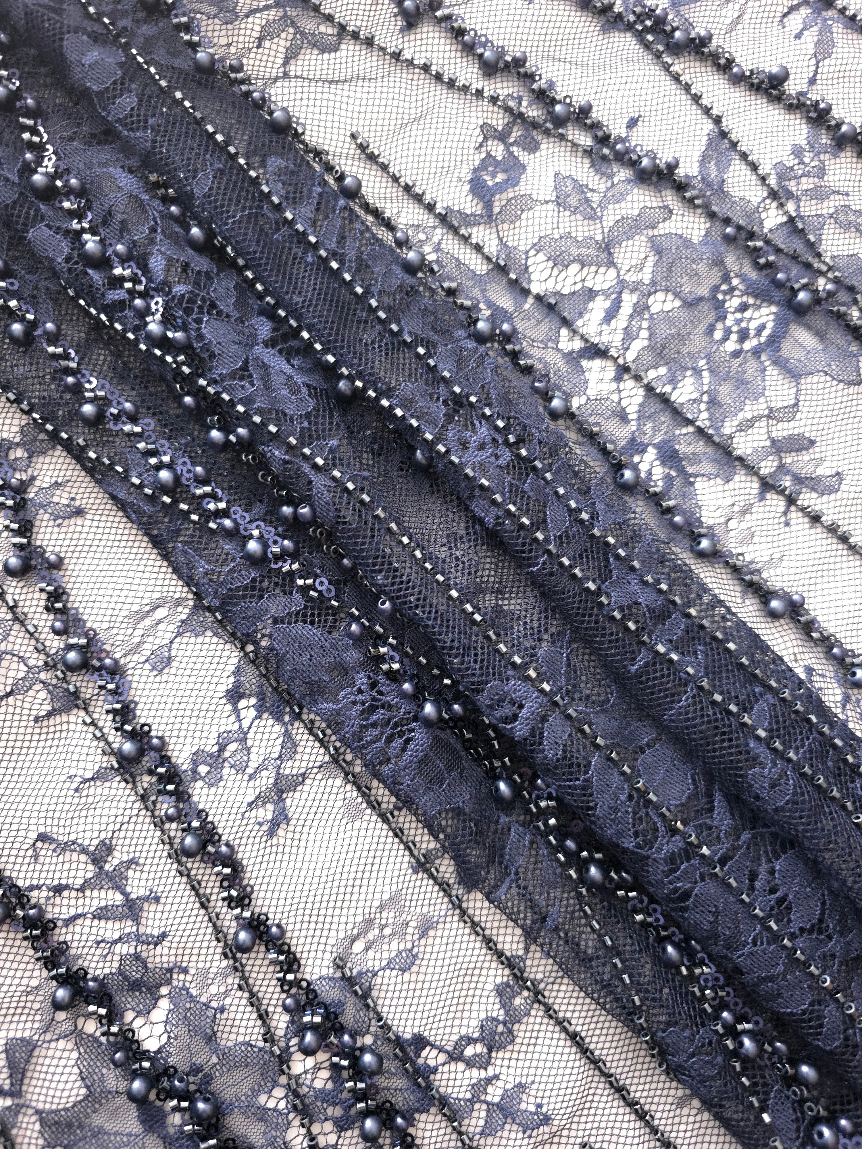 Slate Blue Botanical Pearl couture lace in a gathered sparkling lace presentation, highlighting branching botanical vines with pearl-like beading.