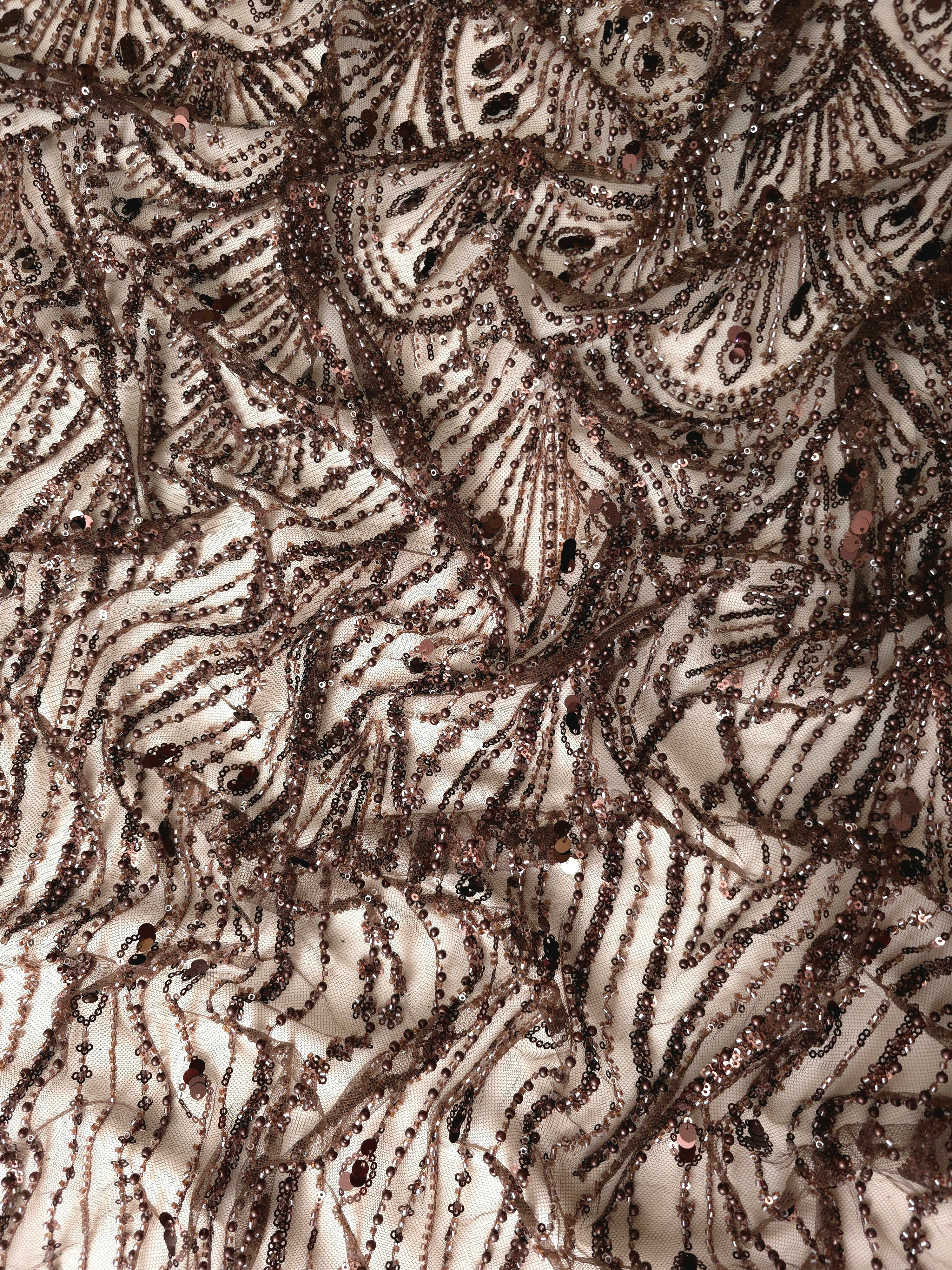 Antique Bronze Art Deco Cascade couture lace in a gathered shimmering embroidery presentation, highlighting cascading ornamental details and Deco-inspired beadwork.