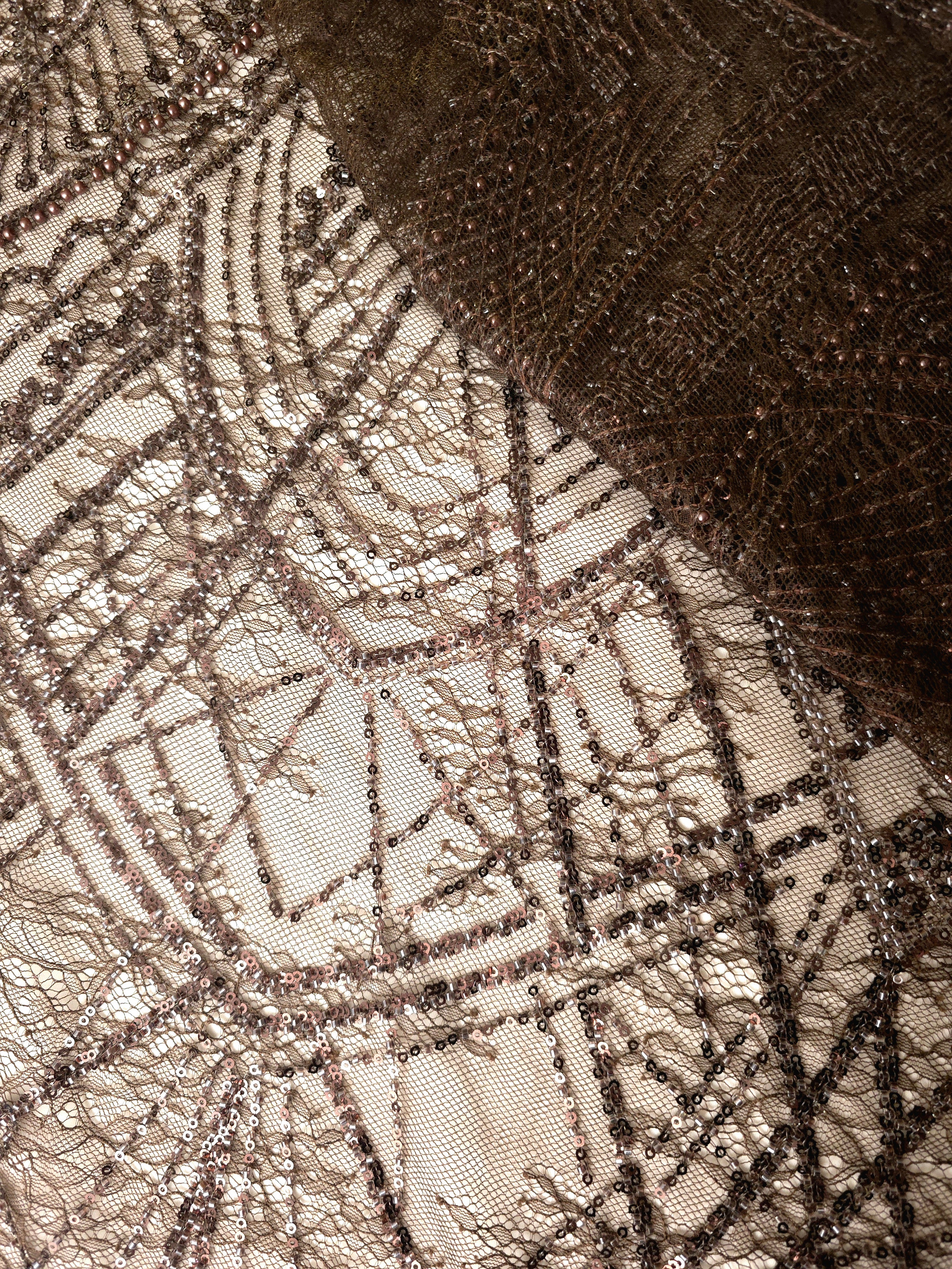 Antique Taupe Ornate Deco Fan couture lace in a folded decorative mesh presentation, highlighting repeating fan arches and geometric embroidery.