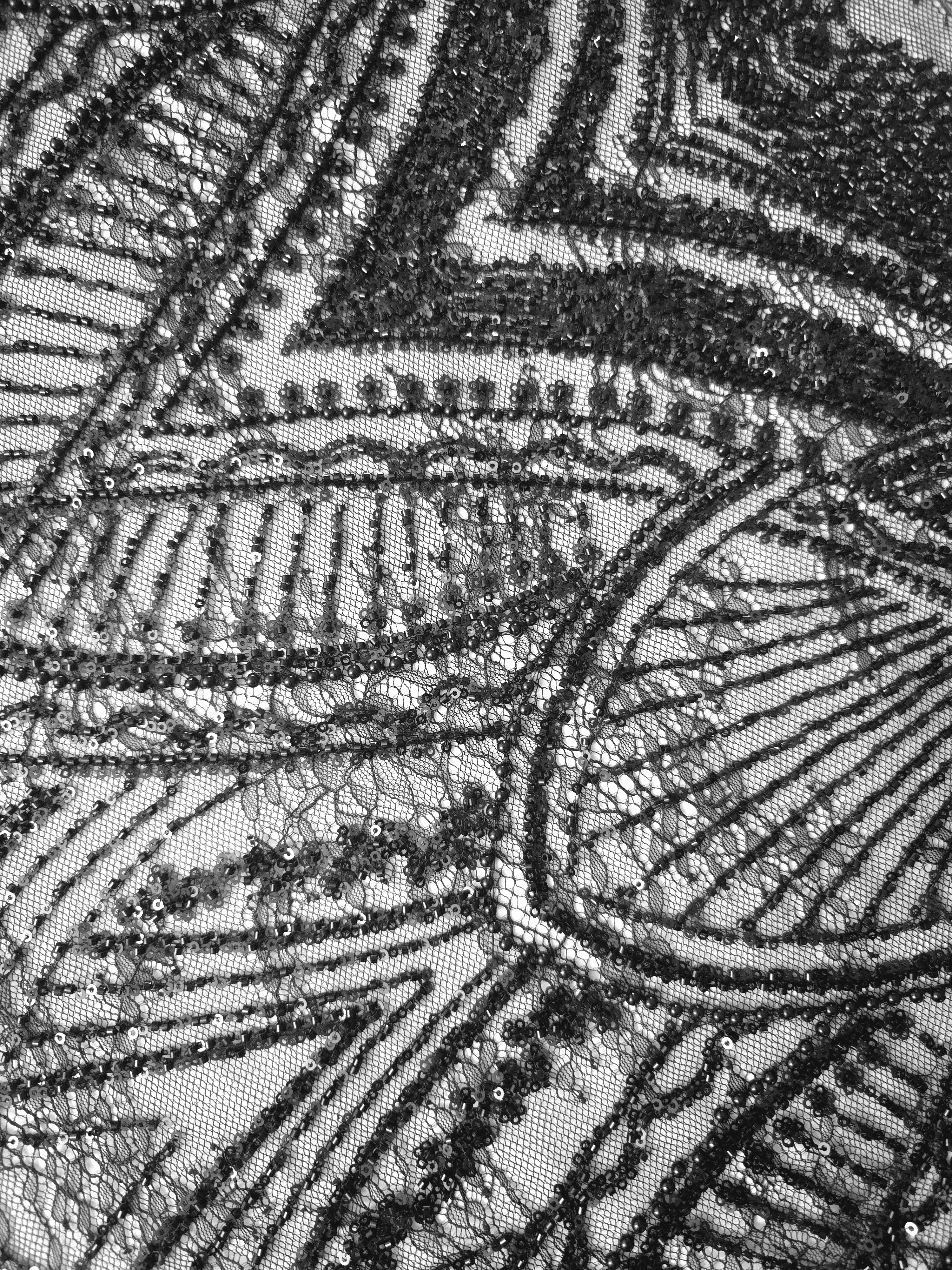 Jet Black Ornate Deco Fan embellished lace displaying radiating sequin embroidery, with repeating fan arches and geometric embroidery.