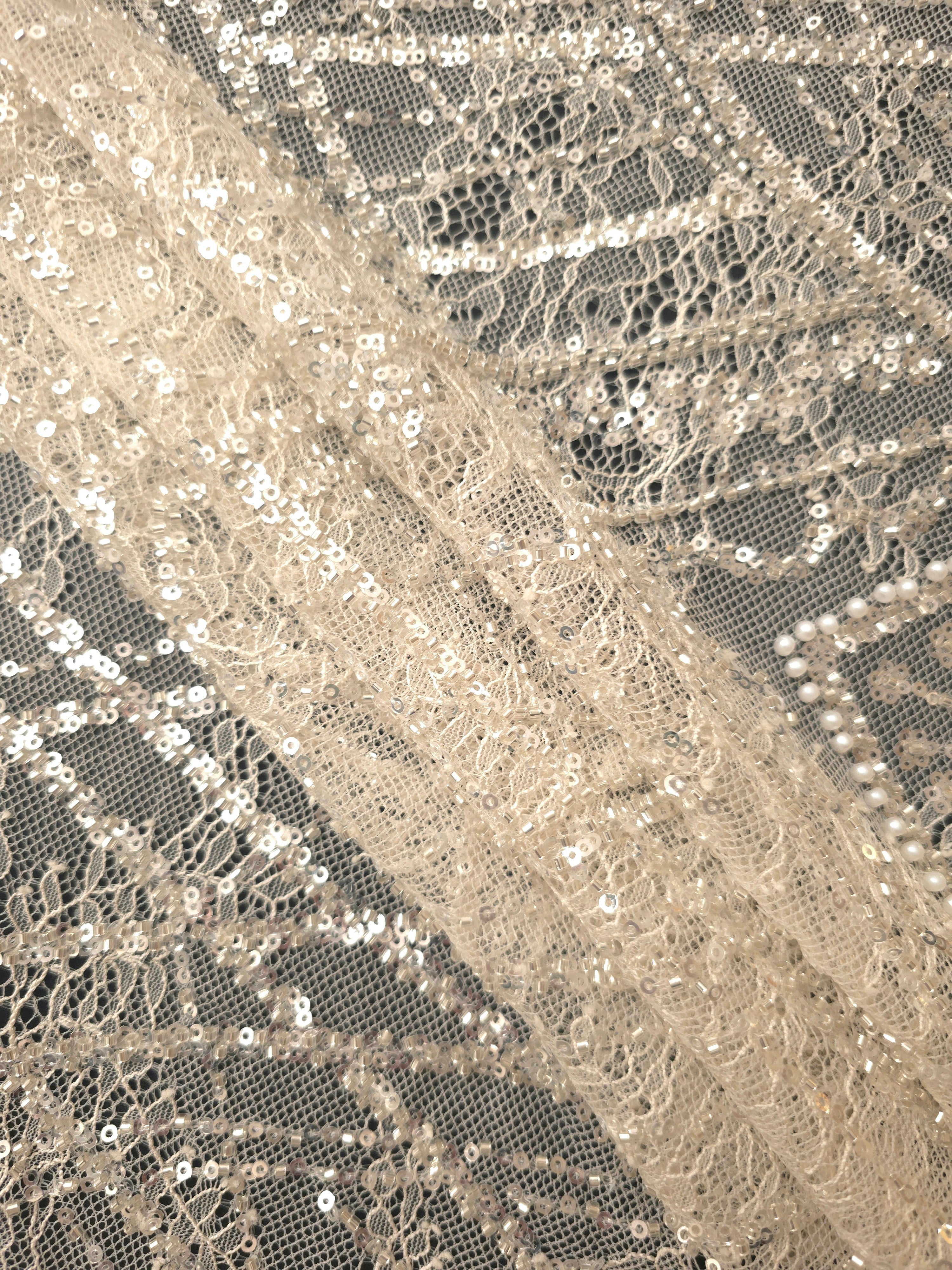 Close-up of Soft Ivory Ornate Deco Fan beaded lace showing fine line fan pattern closeup, with repeating fan arches and geometric embroidery.