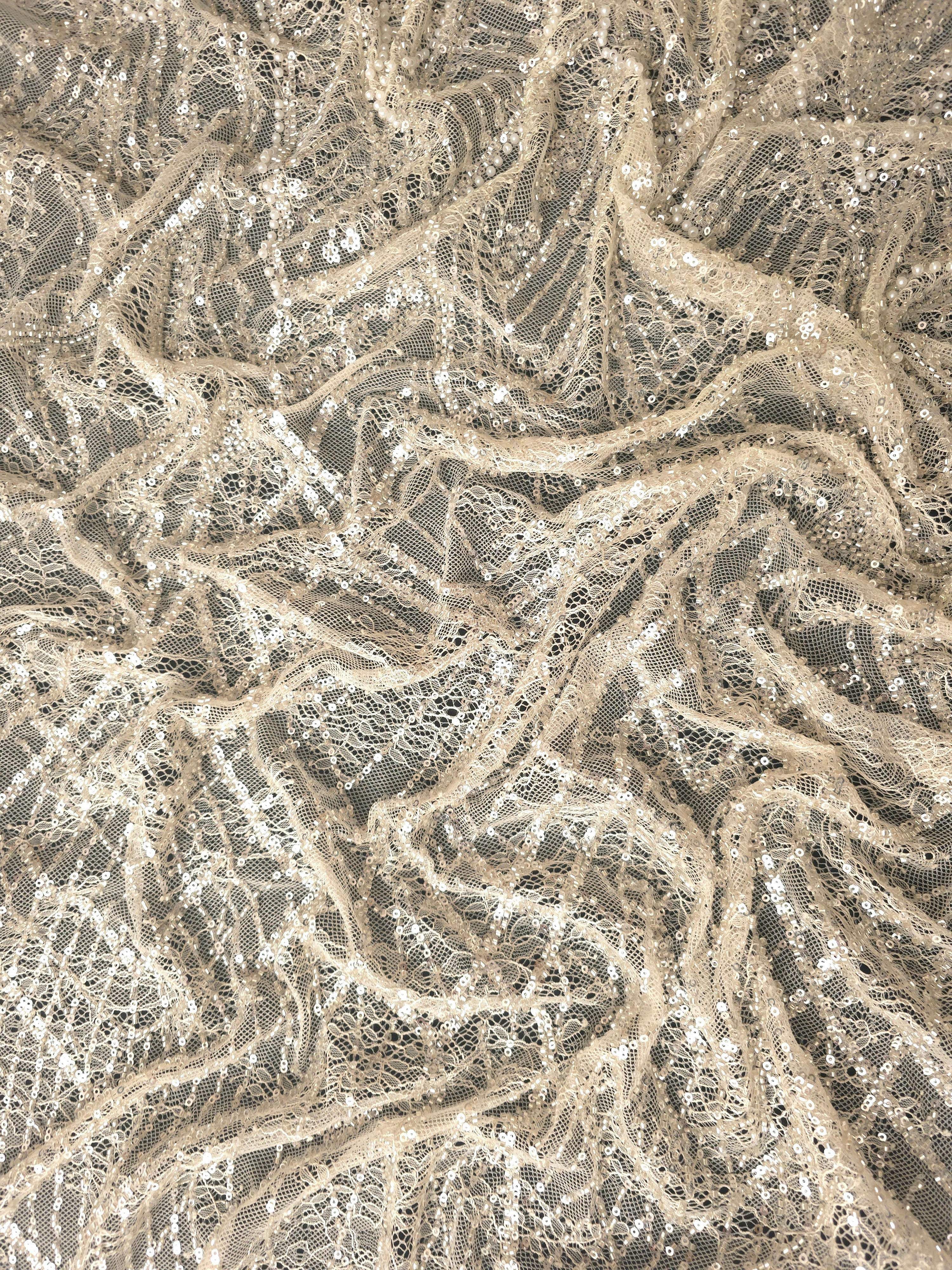 Close-up of Soft Ivory Ornate Deco Fan beaded lace showing raised sequin net macro, with repeating fan arches and geometric embroidery.