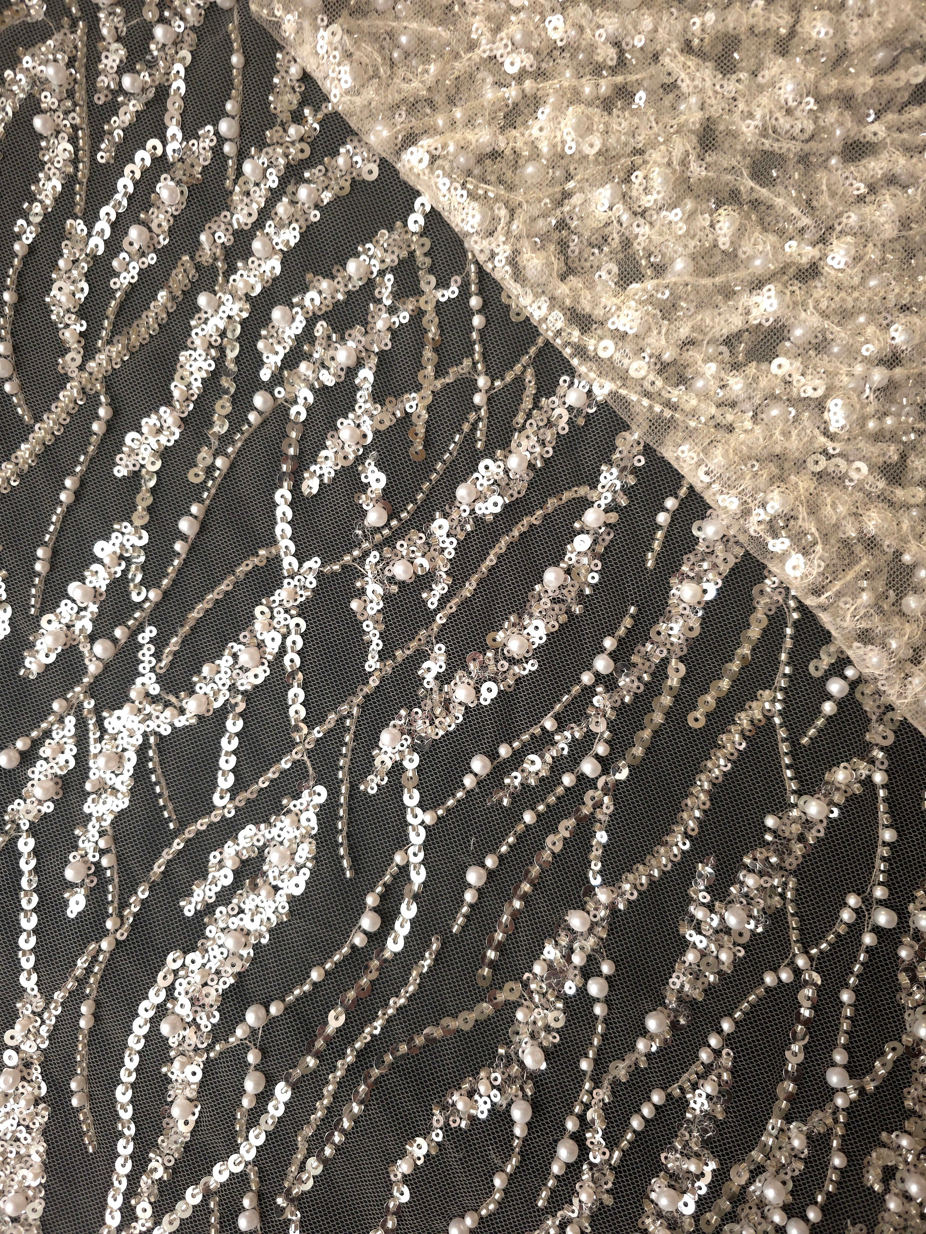 Ivory Silver Liquid Wave couture lace in a liquid line mesh layering presentation, highlighting flowing ripples and curved sequin embellishment.