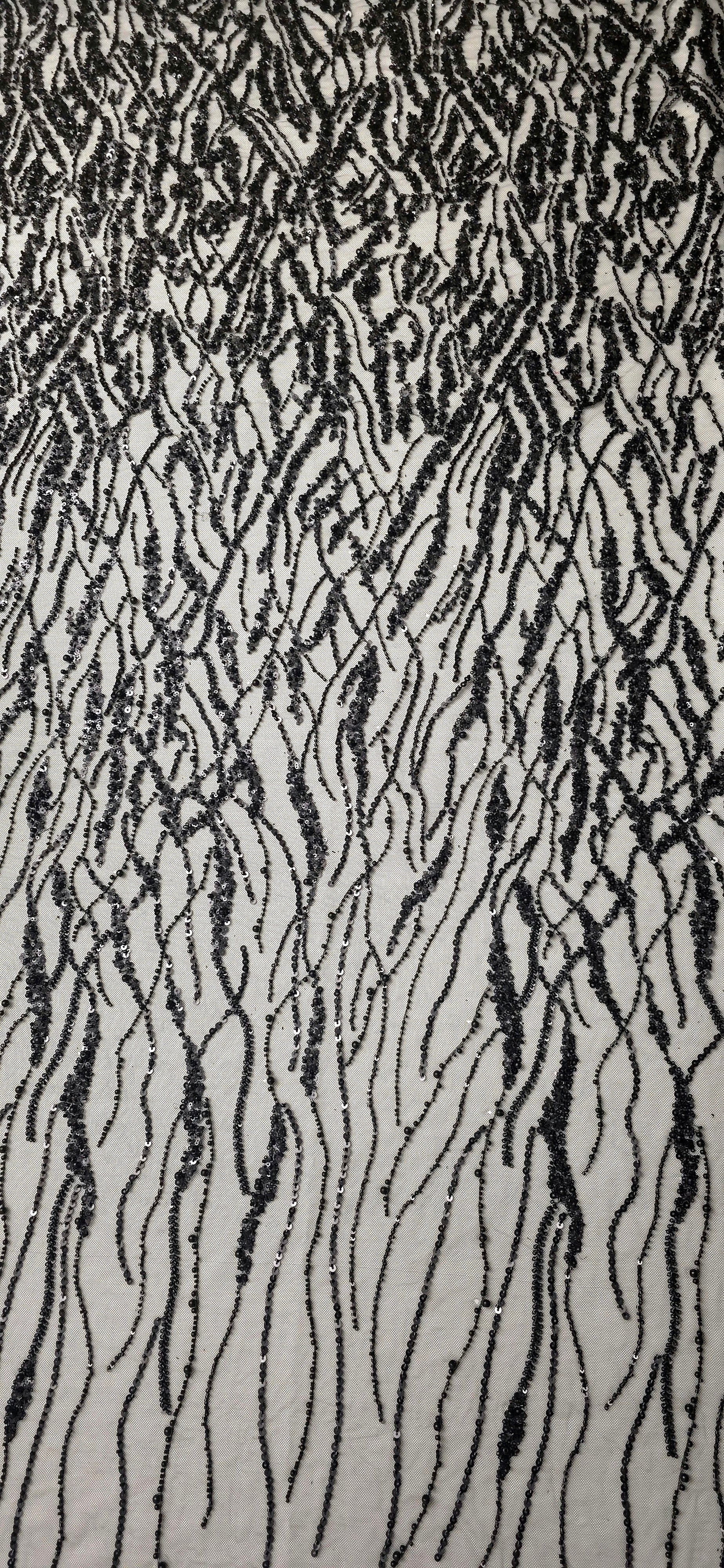 Jet Black Liquid Wave embroidered lace showing black flowing wave motif across a decorative mesh with flowing ripples and curved sequin embellishment.