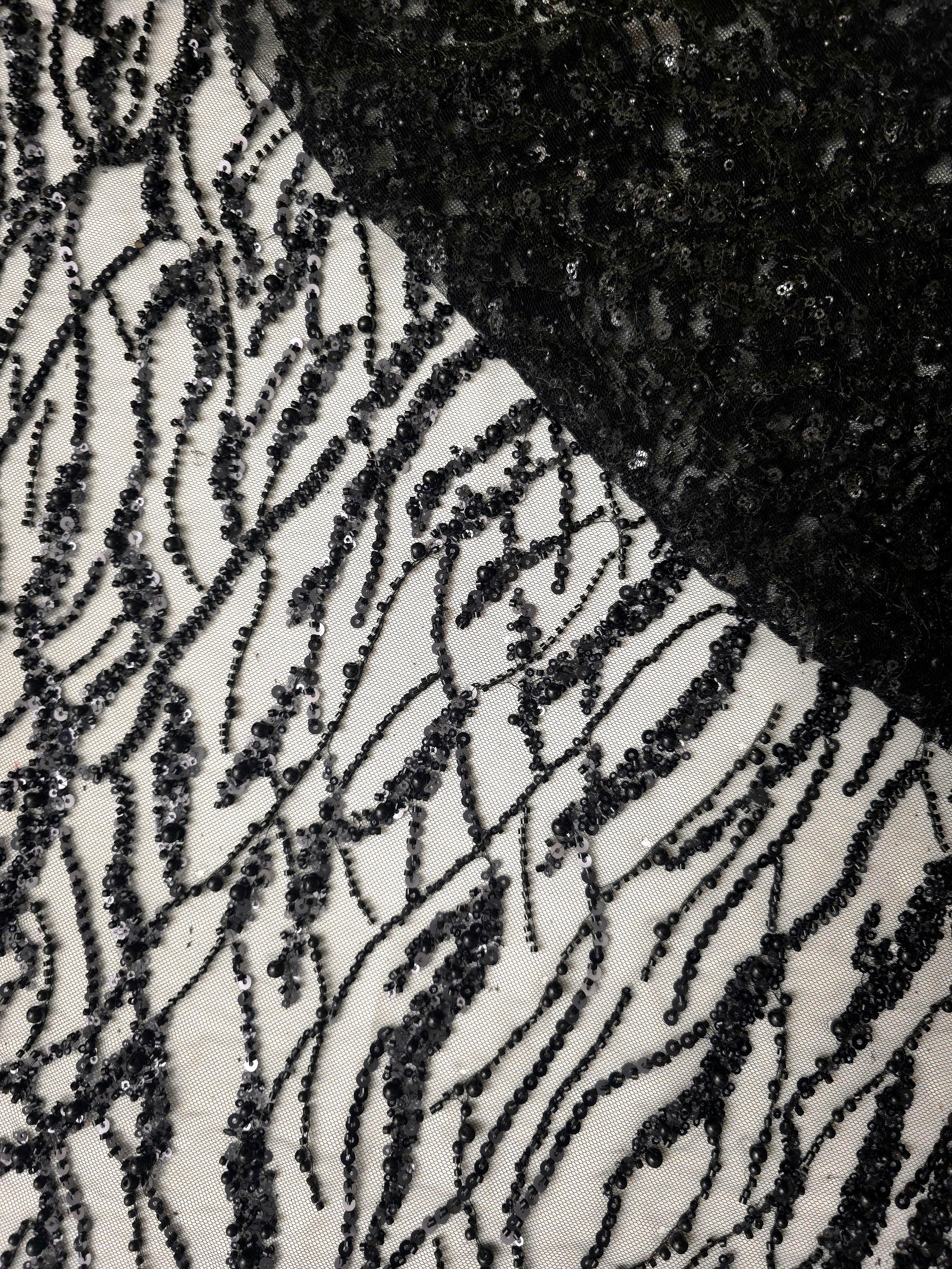 Jet Black Liquid Wave couture lace in a draped abstract wave lace presentation, highlighting flowing ripples and curved sequin embellishment.