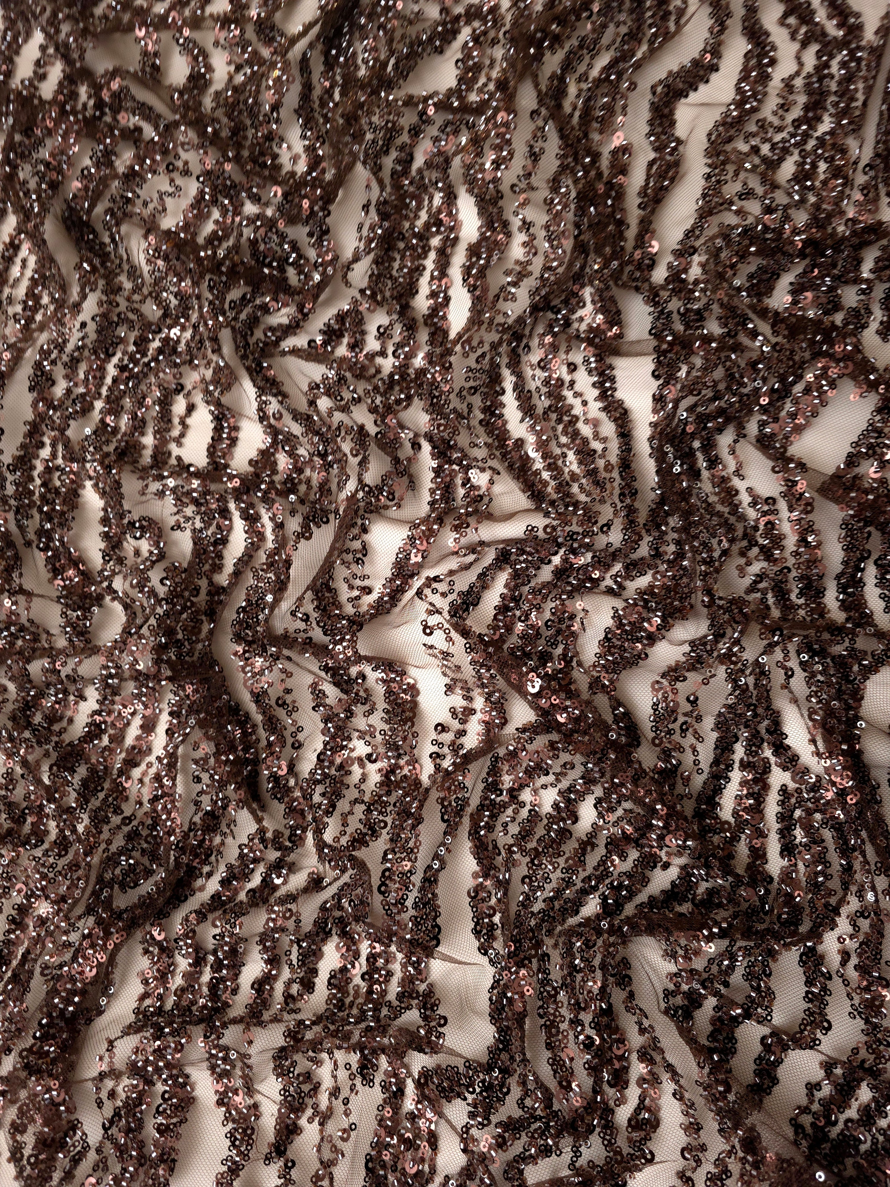 Ruched brown embroidered lace with tightly gathered sequin stripes and pronounced three-dimensional texture.