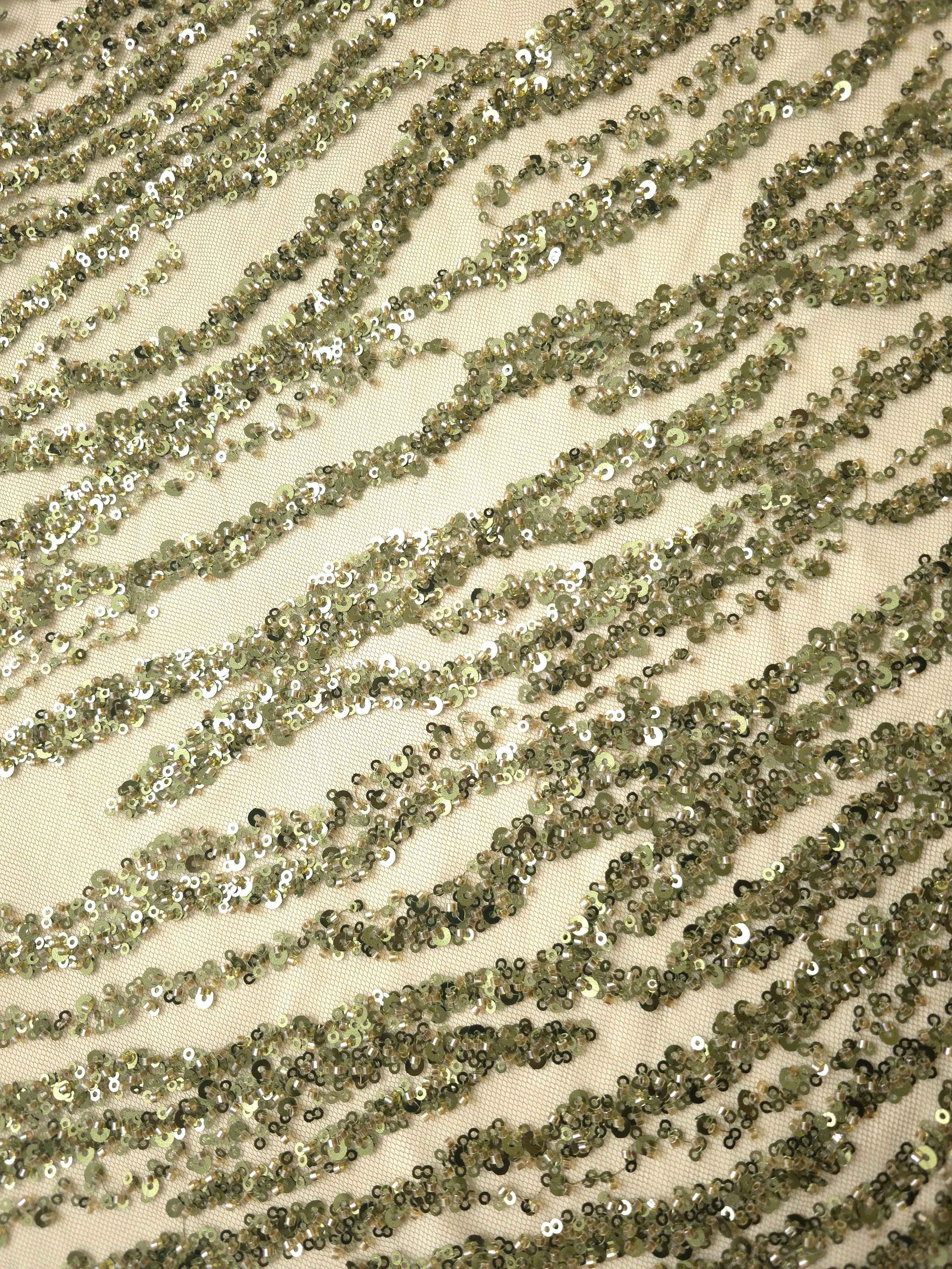 Angled close-up of olive green Zebra Strata lace highlighting shimmering sequin waves on delicate net.
