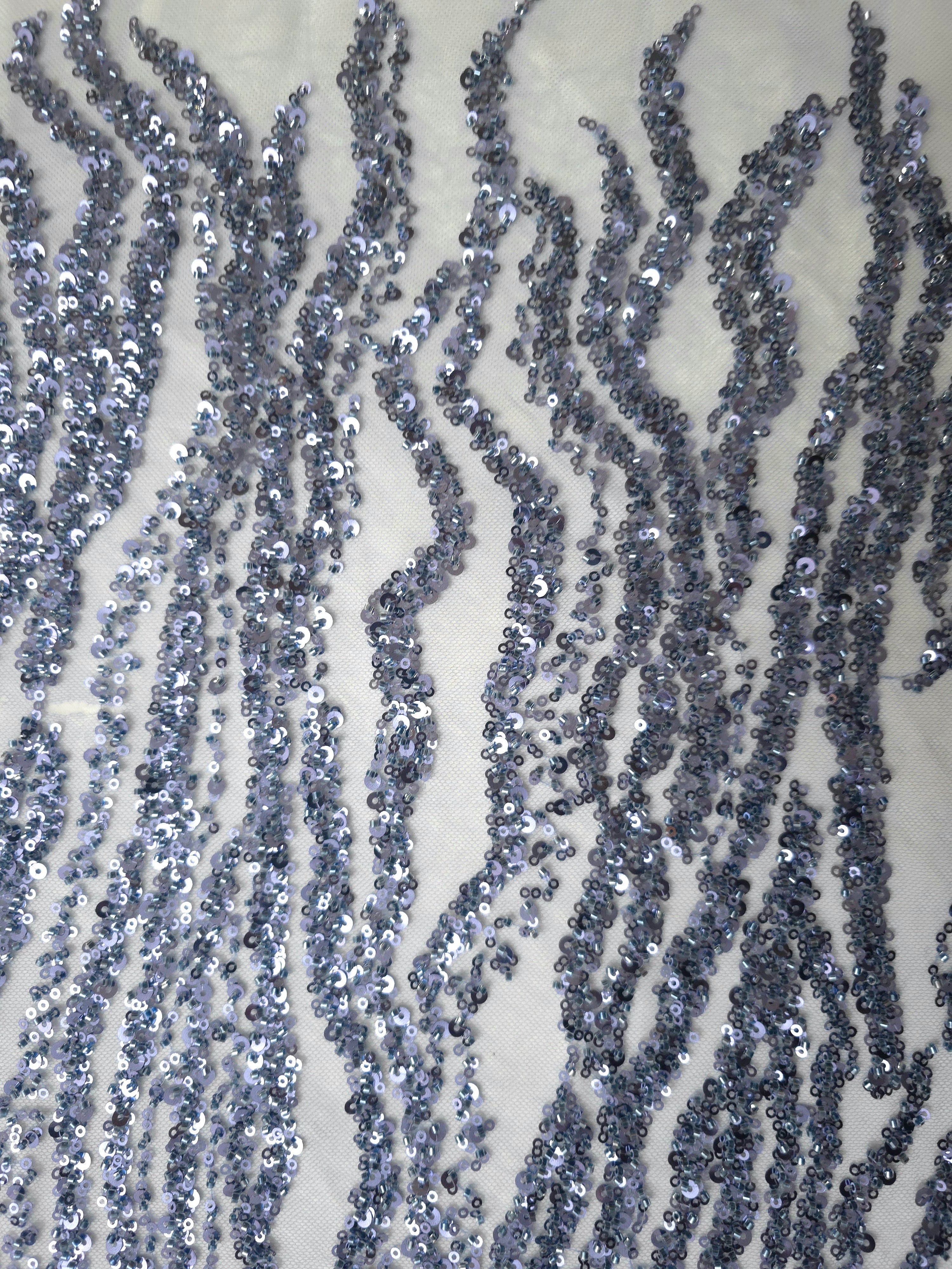 Close view of individual blue sequin rows and narrow embroidered lines following the Zebra Strata motif.