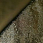 Antique Khaki Lurex Italiano fabric in diagonal folds showing metallic sheen and drape for eveningwear.