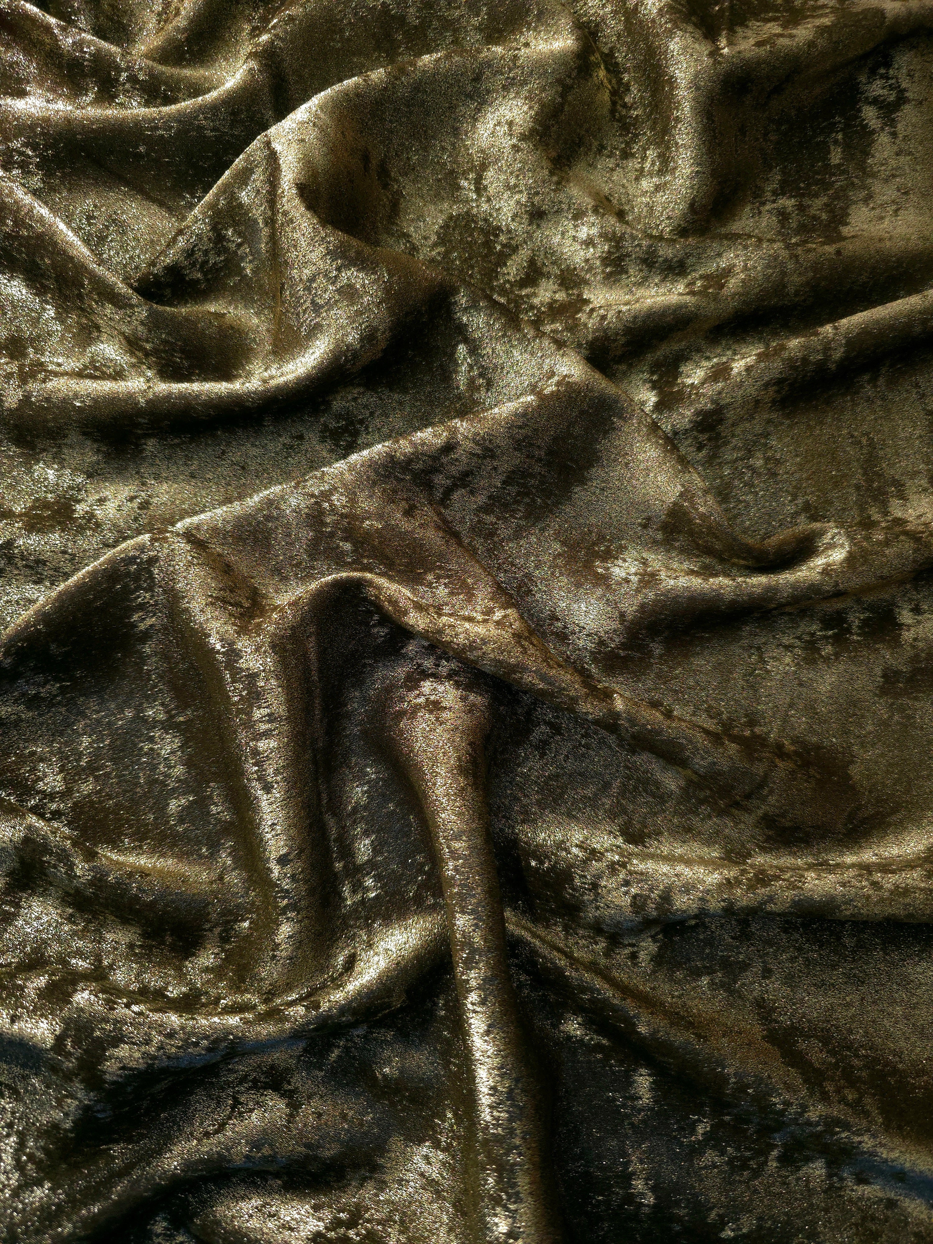 Flowing folds of Antique Khaki Lurex Italiano fabric highlighting drape for abayas, kaftans and dresses.