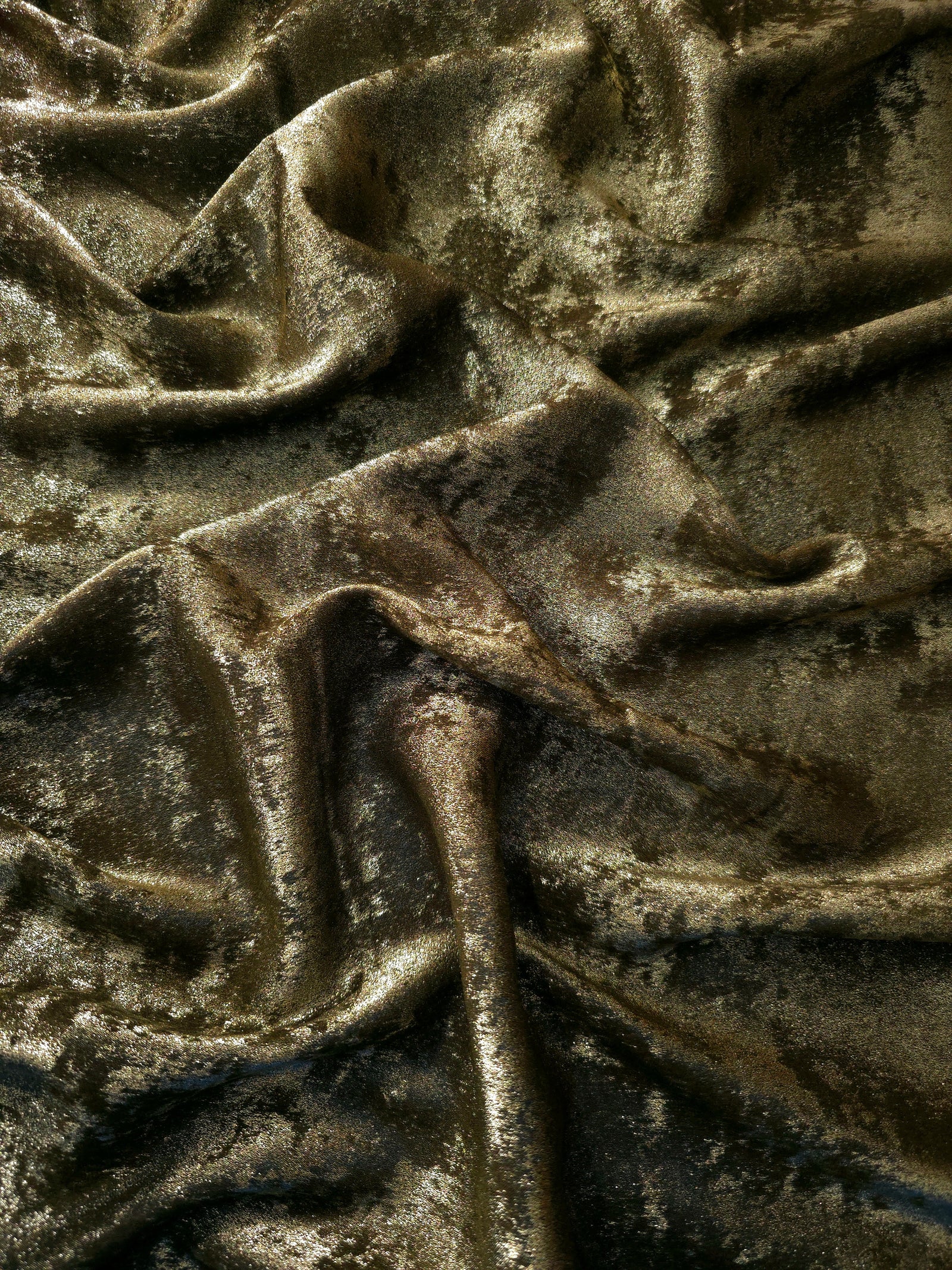 Flowing folds of Antique Khaki Lurex Italiano fabric highlighting drape for abayas, kaftans and dresses.